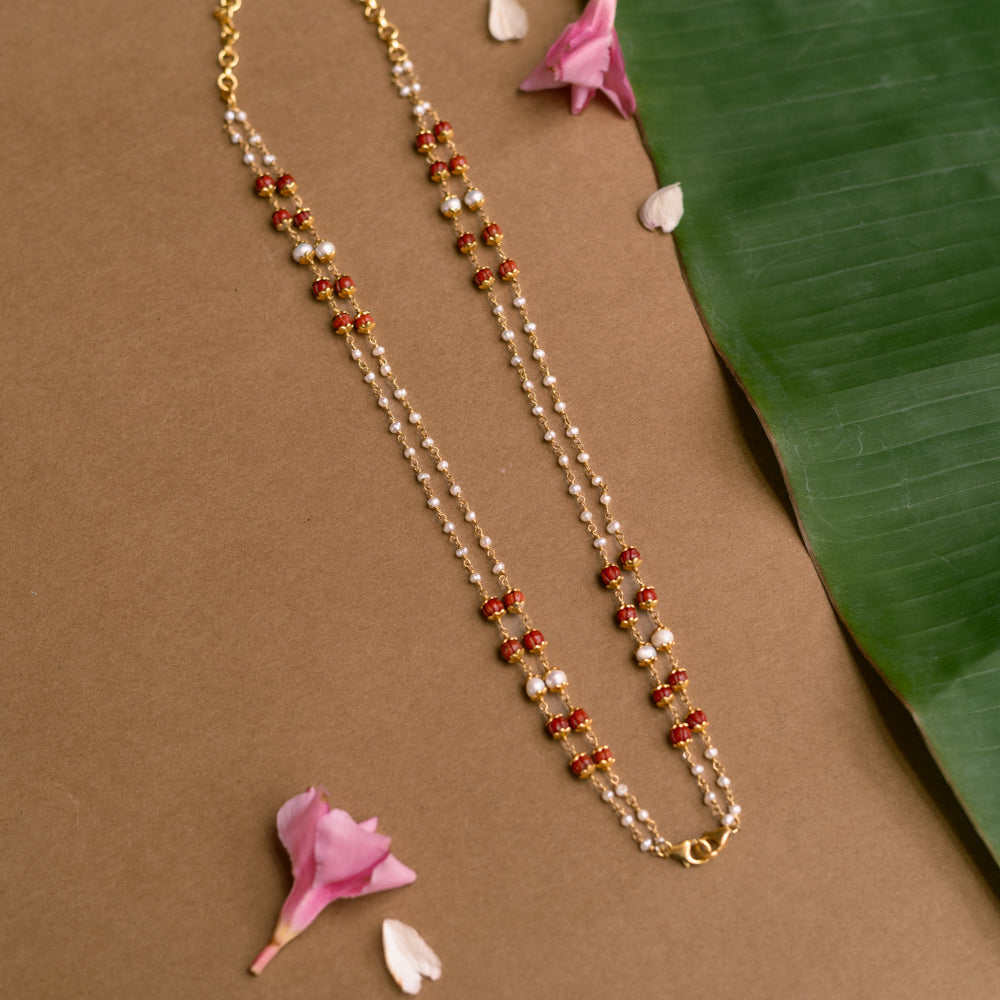 Double-strand chain with red beads and pearls from Hue Collection.