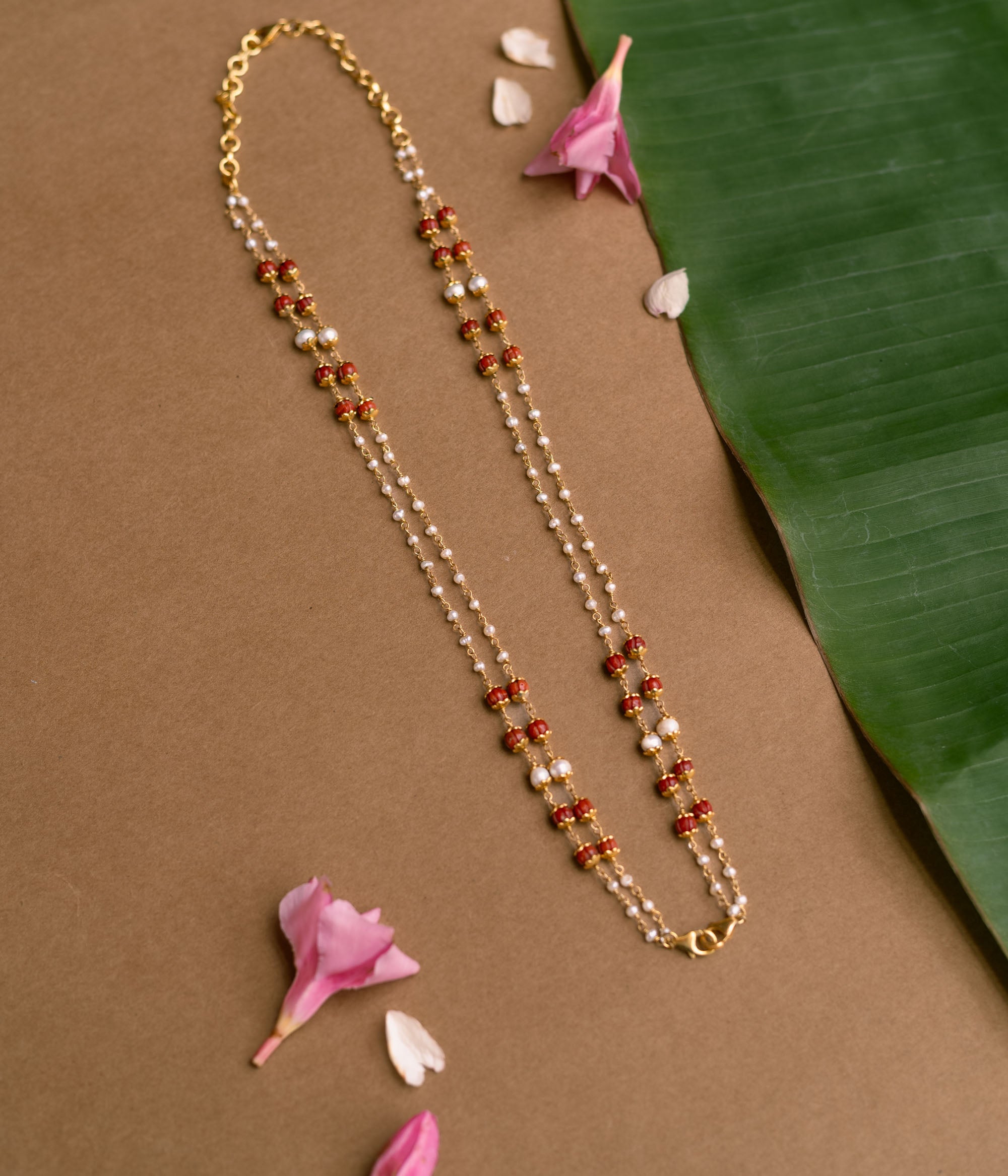 Double-strand chain with red beads and pearls from Hue Collection.