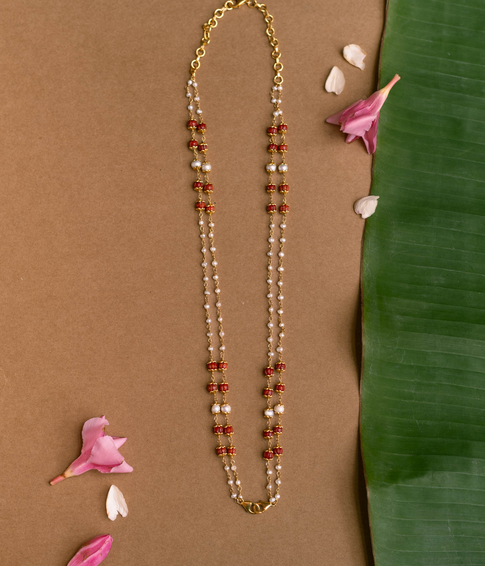 Double-strand chain with red beads and pearls from Hue Collection.