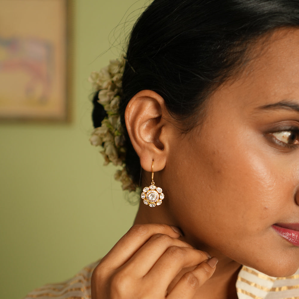 Elegant gold-plated silver floral earrings with a hook design, adorned with sparkling Polki stones, showcasing a timeless and sophisticated look perfect for any occasion.