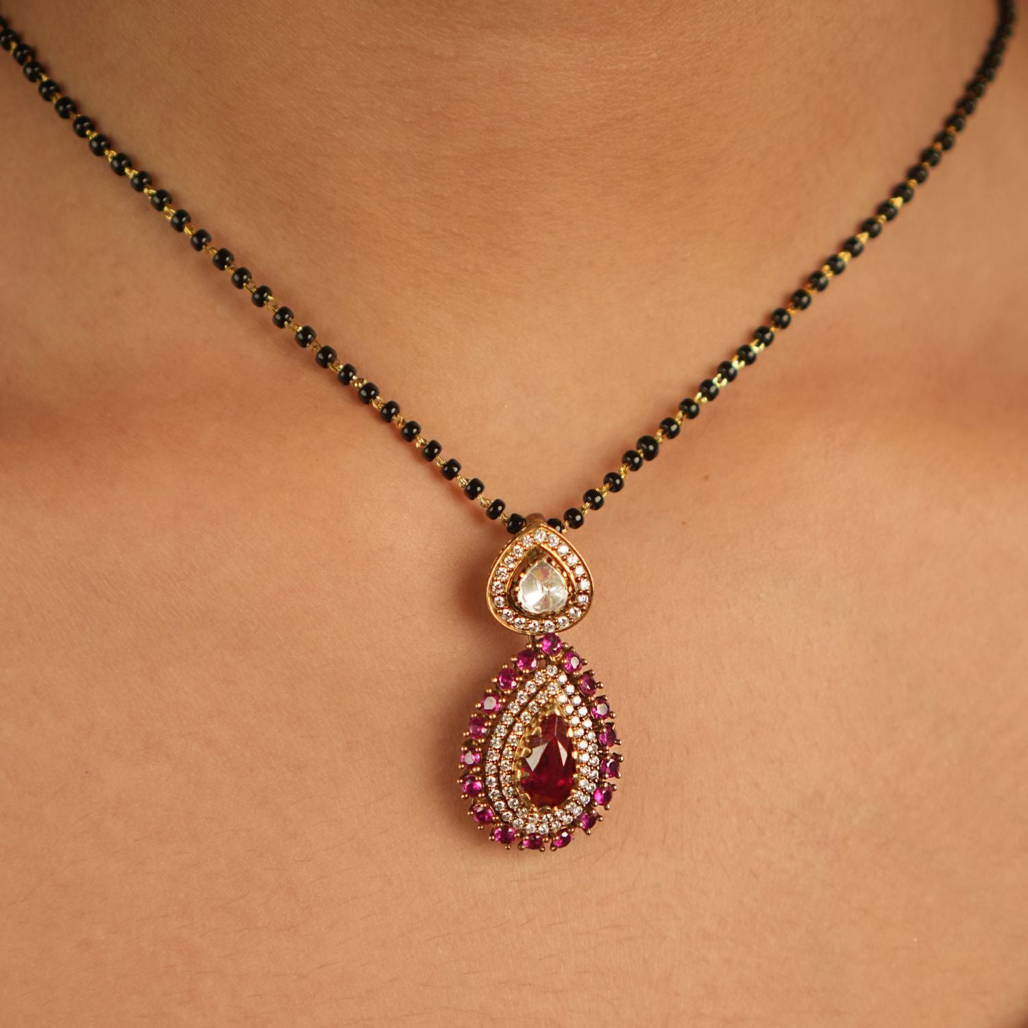 Enhance your jewelry collection with this exquisite teardrop pendant featuring dazzling Moissanite Polki stones, sparkling CZ stones, and a vibrant Red Garnet at its center. Designed with meticulous craftsmanship, this pendant offers a sophisticated touch of elegance, making it a perfect addition to your collection.