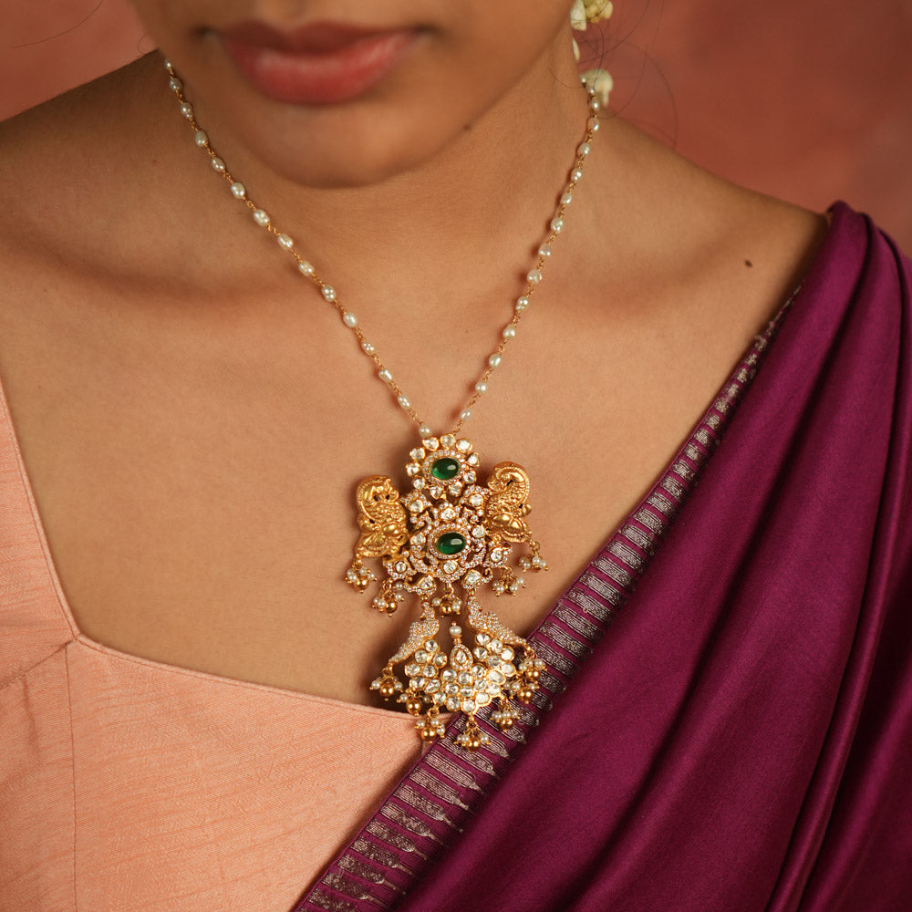 Moissanite Polki stones, CZ stones, and green gemstone pendant: Regal peacocks shimmer with elegance, whispering timeless charm and opulence.