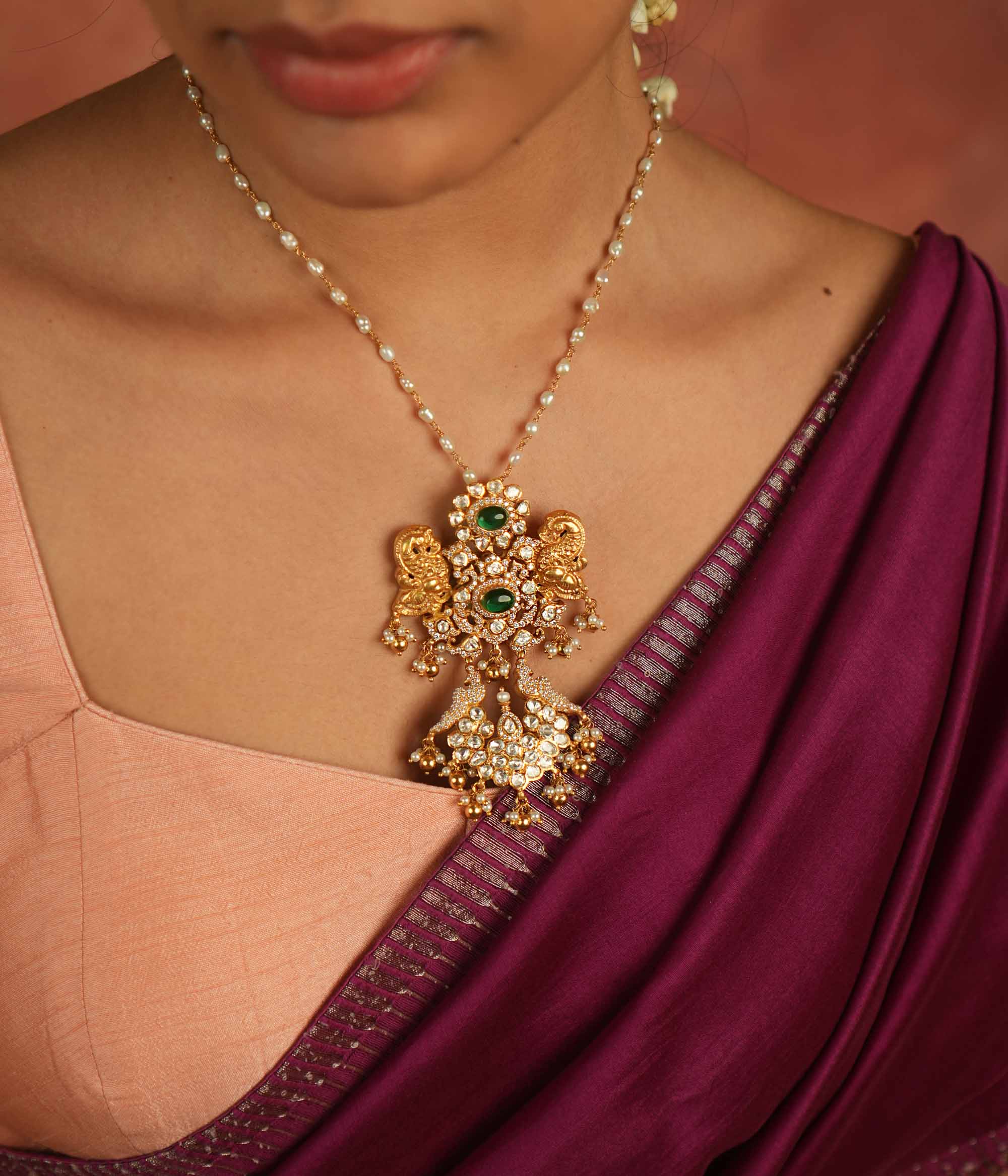 Moissanite Polki stones, CZ stones, and green gemstone pendant: Regal peacocks shimmer with elegance, whispering timeless charm and opulence.