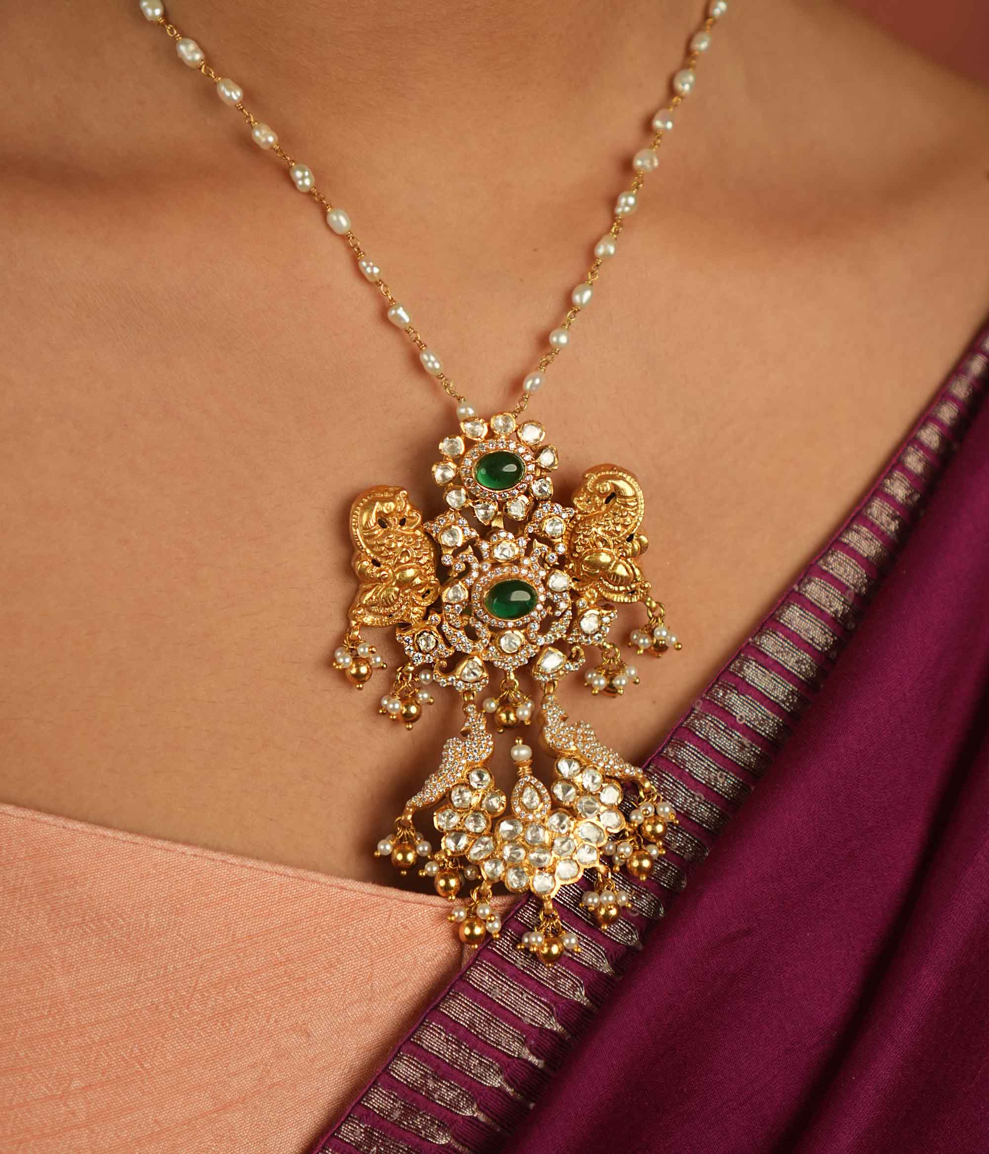 Moissanite Polki stones, CZ stones, and green gemstone pendant: Regal peacocks shimmer with elegance, whispering timeless charm and opulence.