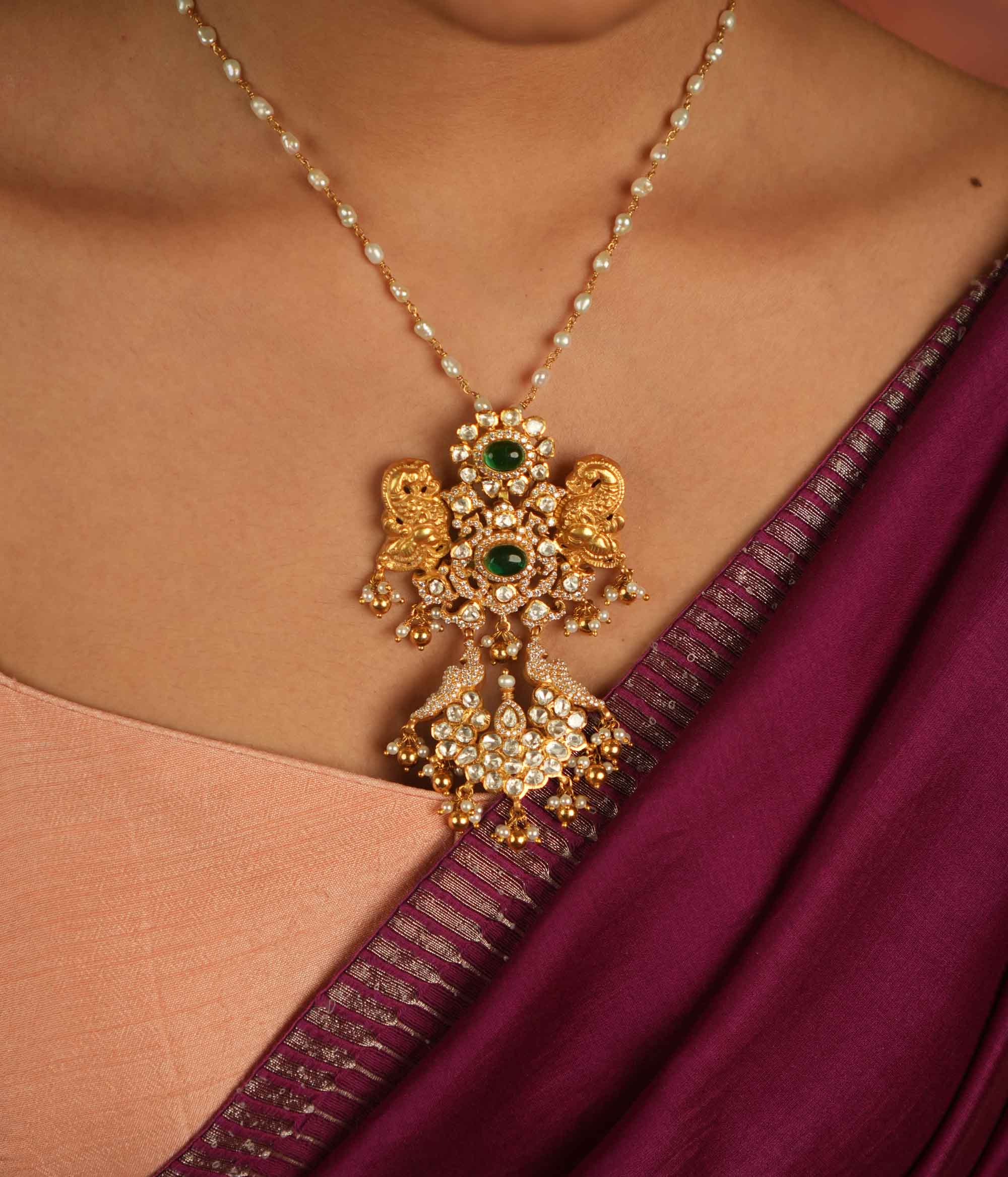Moissanite Polki stones, CZ stones, and green gemstone pendant: Regal peacocks shimmer with elegance, whispering timeless charm and opulence.