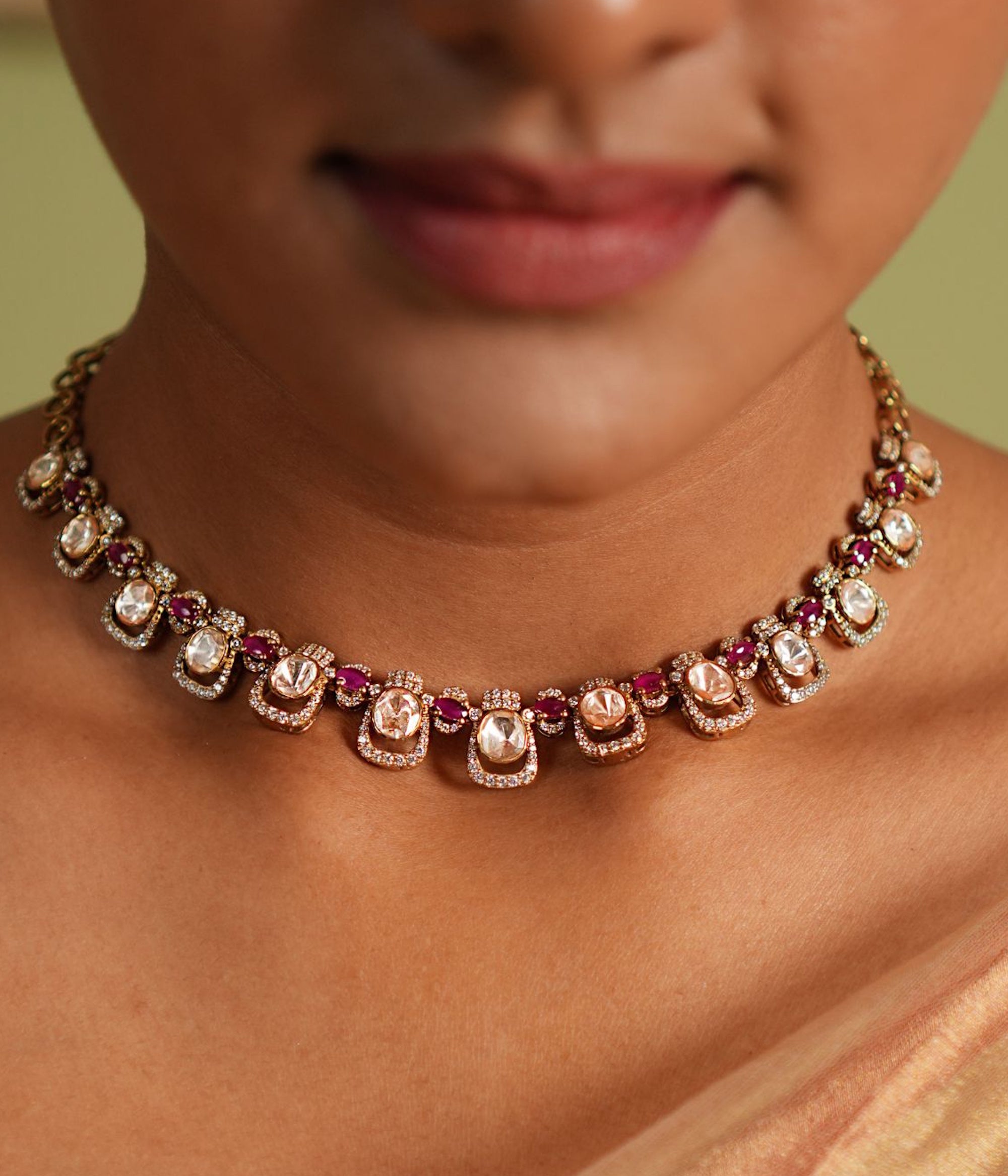 Close-up of a person wearing a decorative necklace with gemstones.