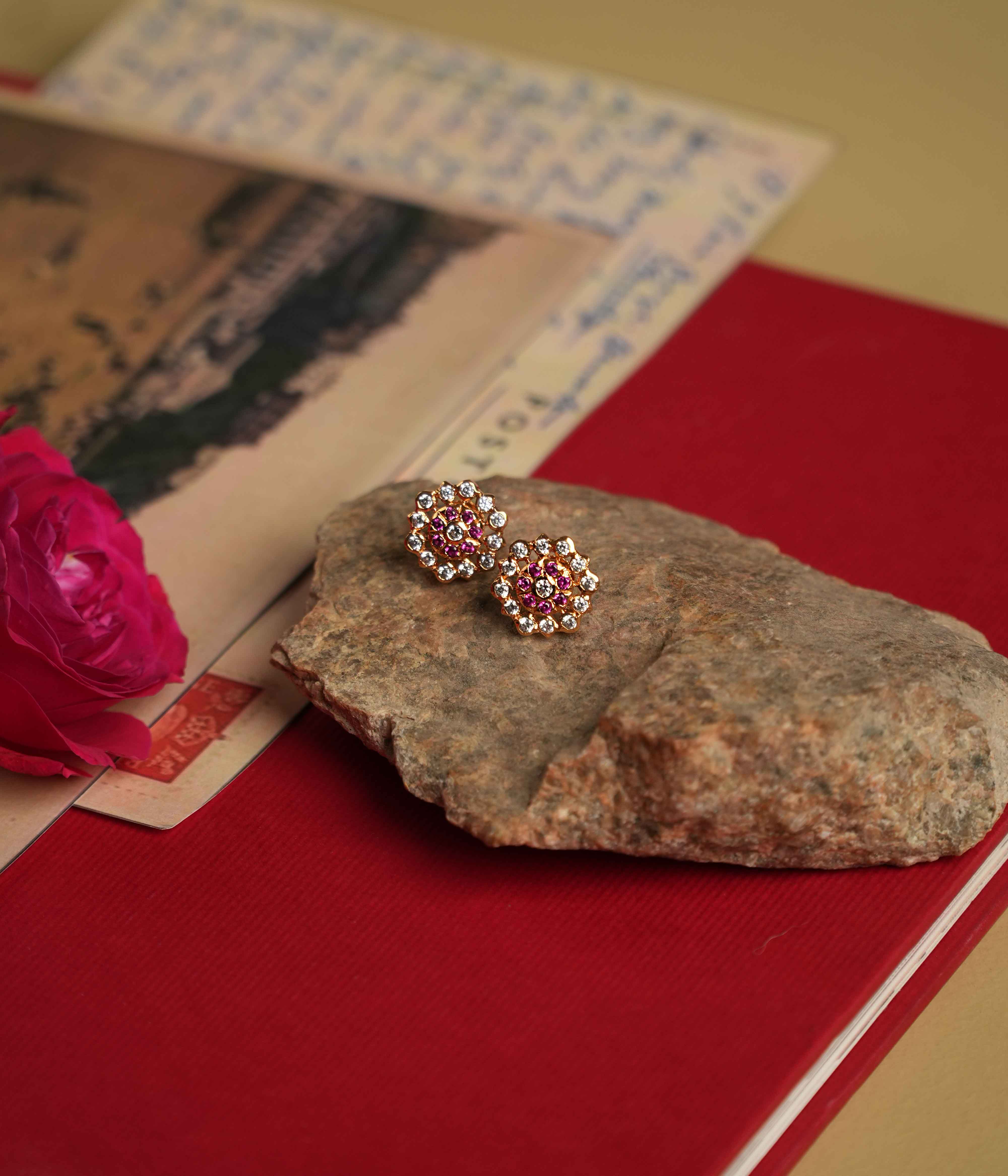 The Hasumathi Ear Stud: Minimalist 92.5 sterling silver ear studs with South screw fastening, featuring Swarovski crystals and red gemstone accents, inspired by the revered stone settings of Chettinad.