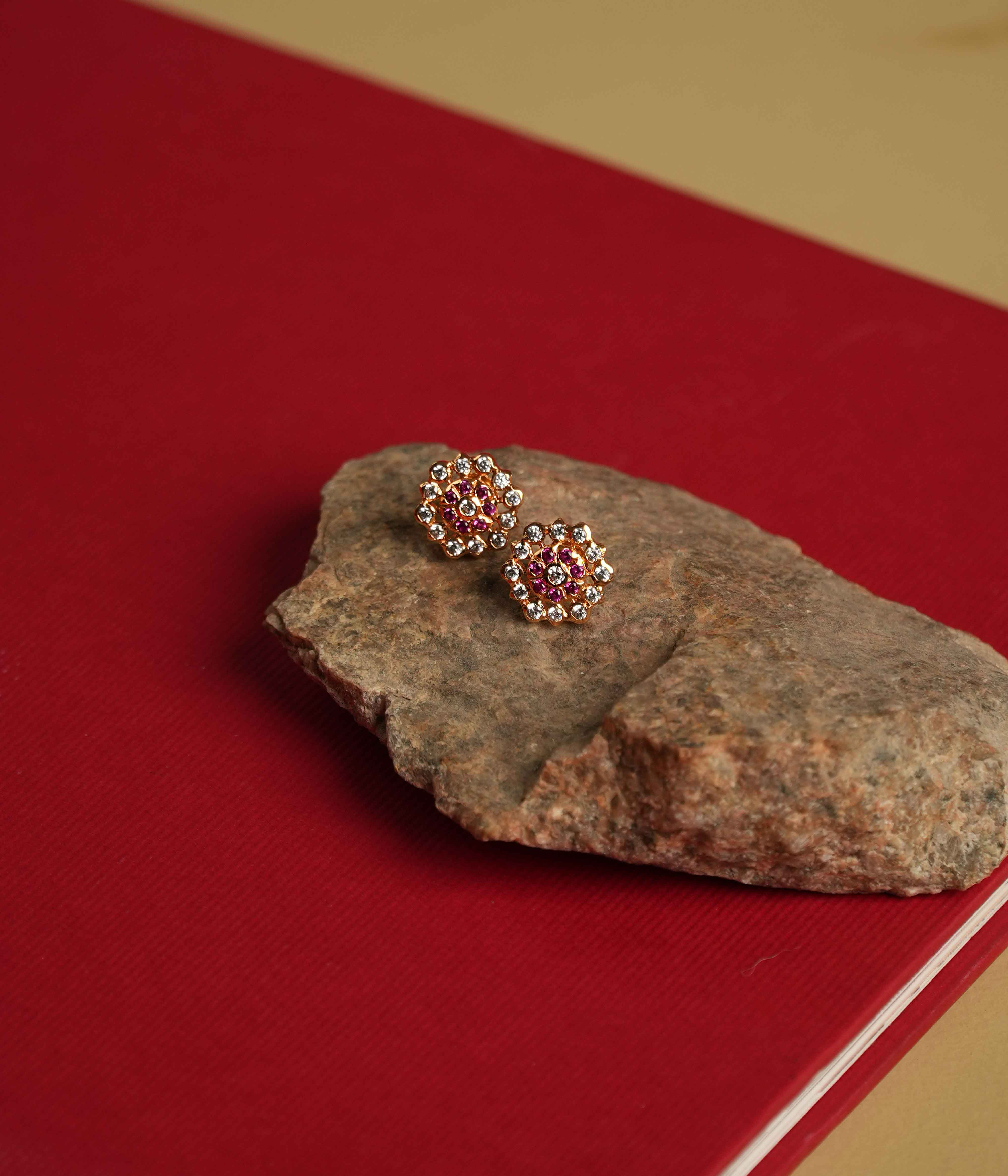 The Hasumathi Ear Stud: Minimalist 92.5 sterling silver ear studs with South screw fastening, featuring Swarovski crystals and red gemstone accents, inspired by the revered stone settings of Chettinad.
