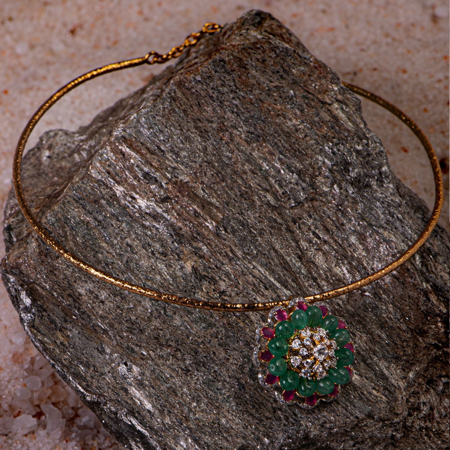 Gold-plated silver pendant with a round shape, featuring a stunning floral arrangement of Moissanite Polki stones, pink tourmaline, and green tourmaline, creating an elegant and timeless design.
