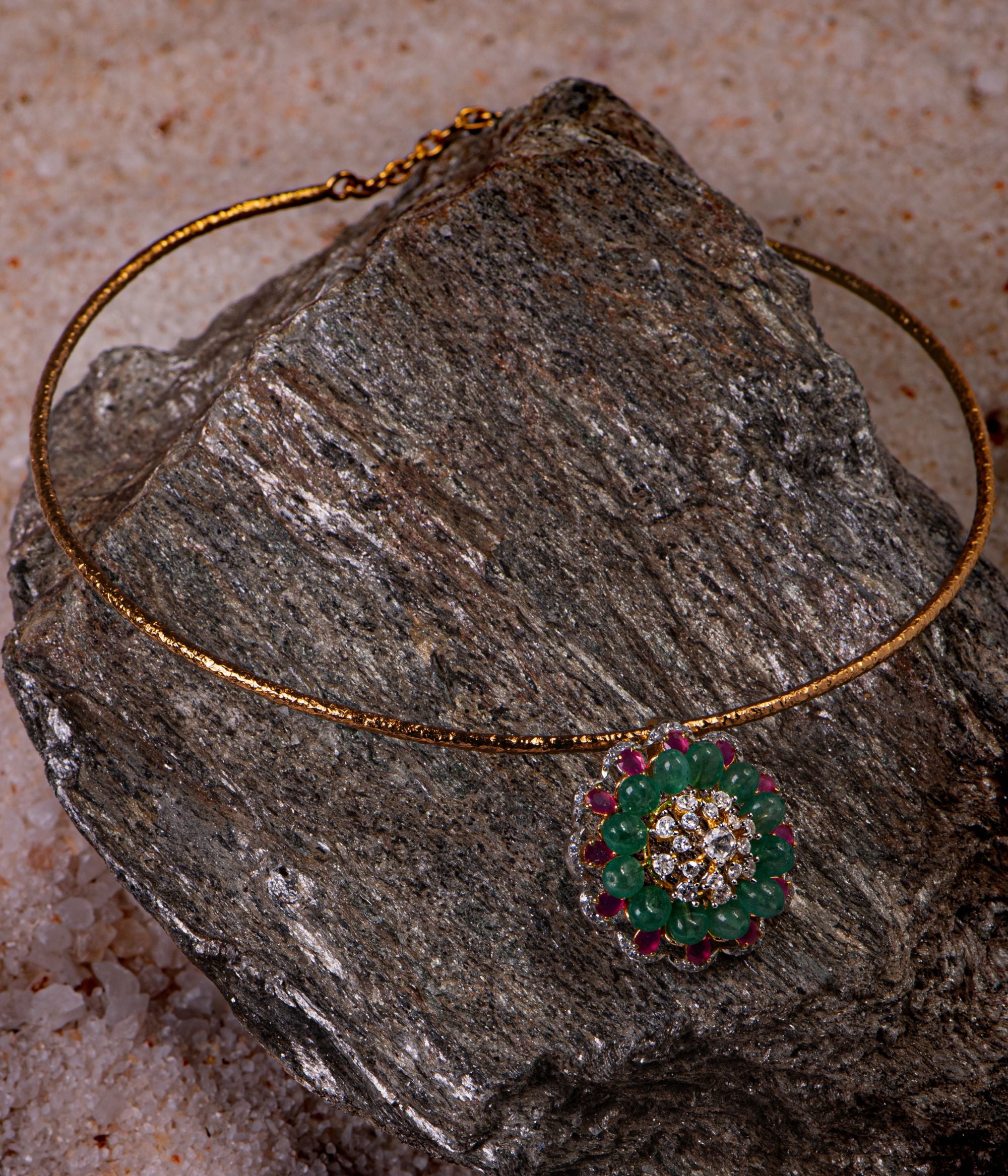 Gold-plated silver pendant with a round shape, featuring a stunning floral arrangement of Moissanite Polki stones, pink tourmaline, and green tourmaline, creating an elegant and timeless design.