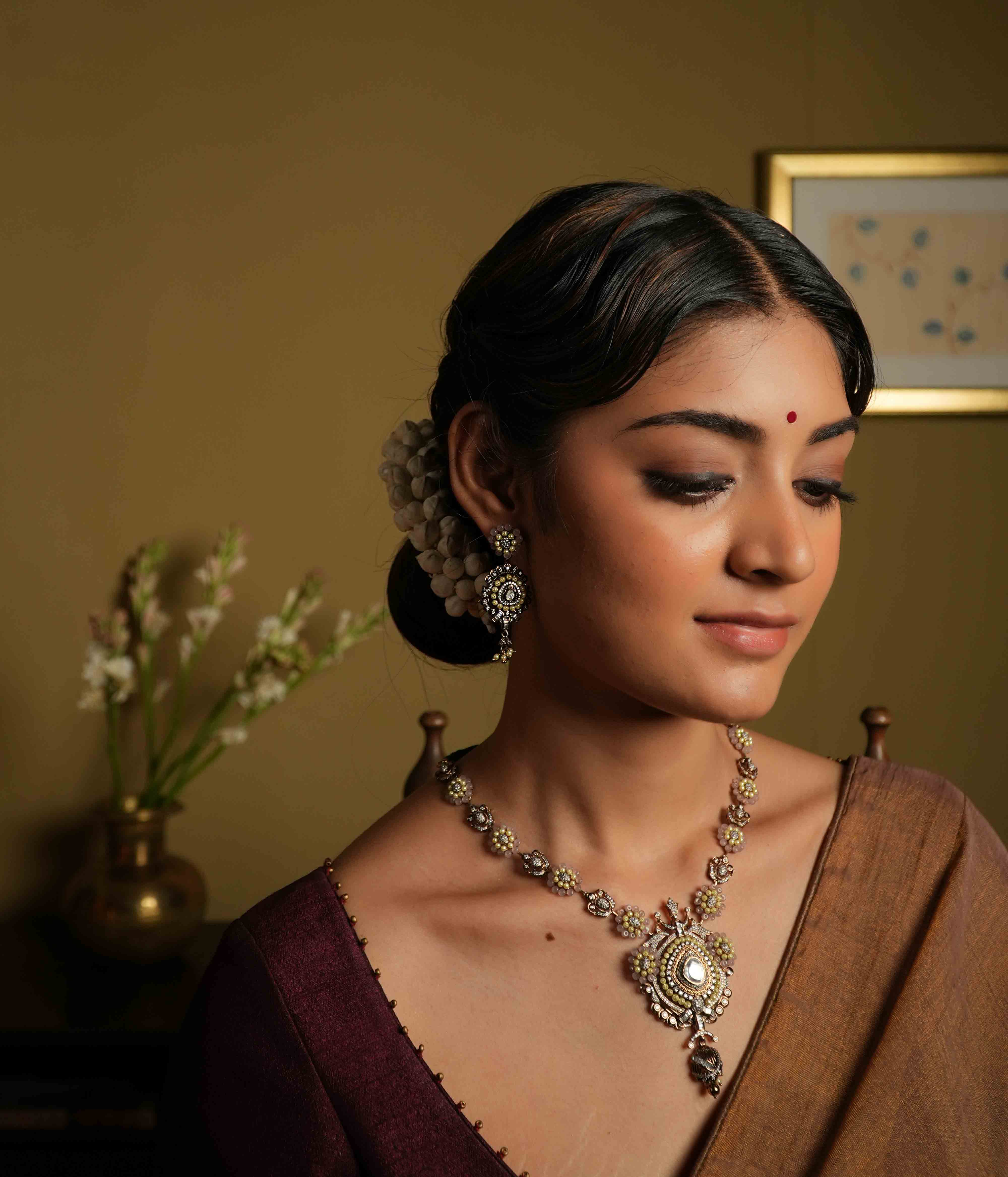 Antique silver earrings crafted from 92.5 sterling silver, featuring lines of lustrous pearls and semi-precious gemstone florals, with a bold teardrop dangle, exuding vintage romance and whimsical charm.