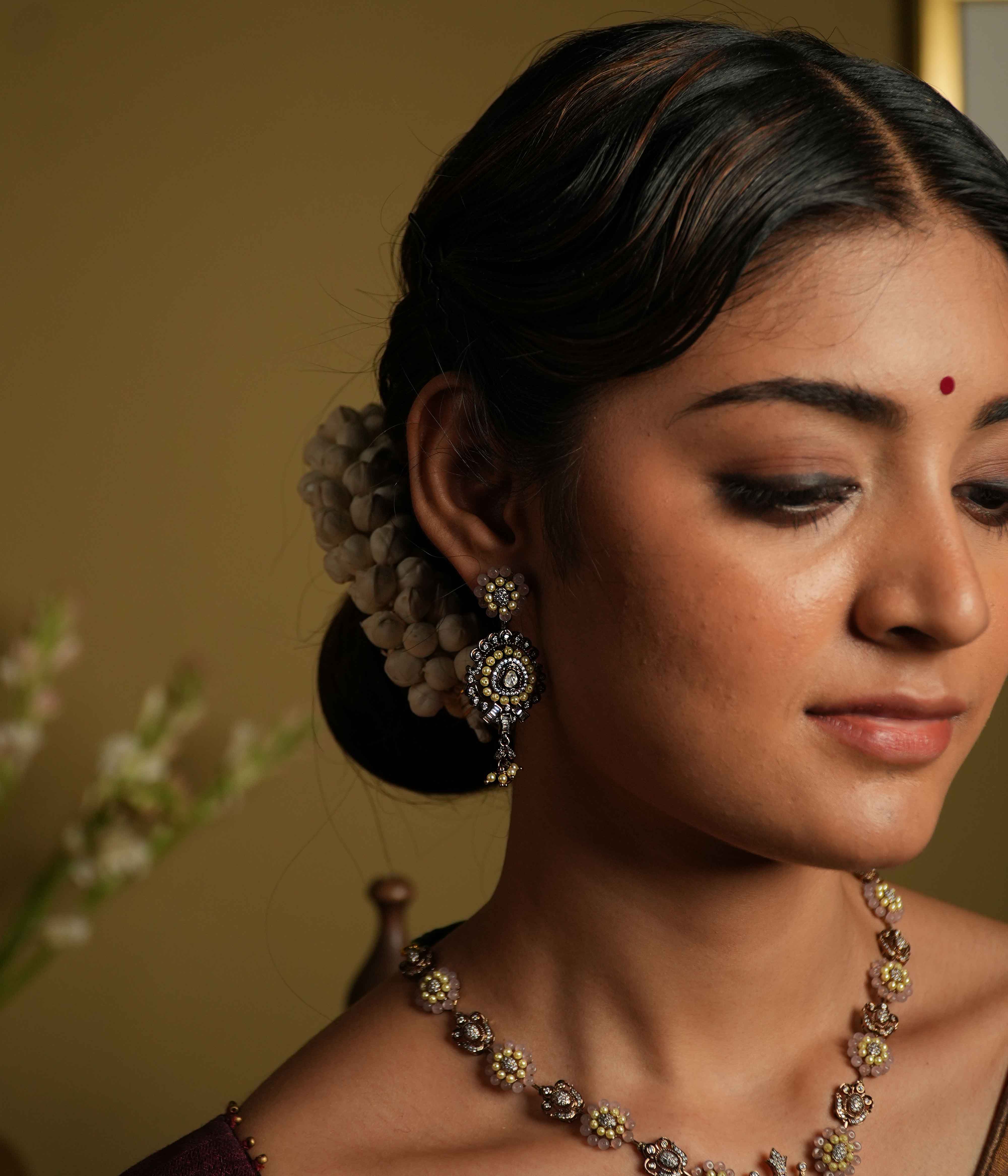 Antique silver earrings crafted from 92.5 sterling silver, featuring lines of lustrous pearls and semi-precious gemstone florals, with a bold teardrop dangle, exuding vintage romance and whimsical charm.