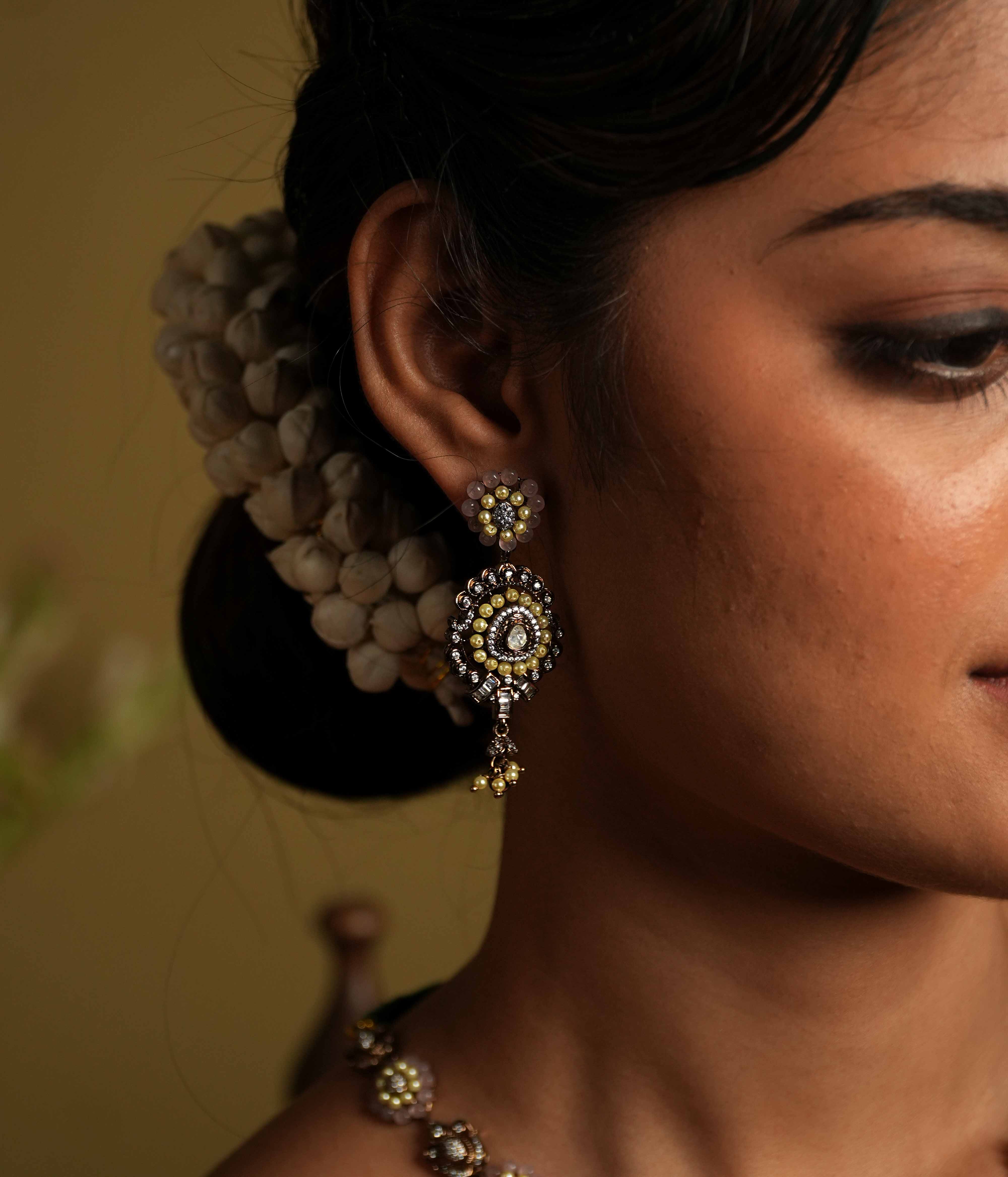 Antique silver earrings crafted from 92.5 sterling silver, featuring lines of lustrous pearls and semi-precious gemstone florals, with a bold teardrop dangle, exuding vintage romance and whimsical charm.