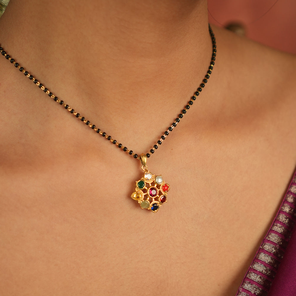 Celestial bloom reborn in a round Navratna pendant, where vibrant gems whisper ancient wisdom with modern elegance.
