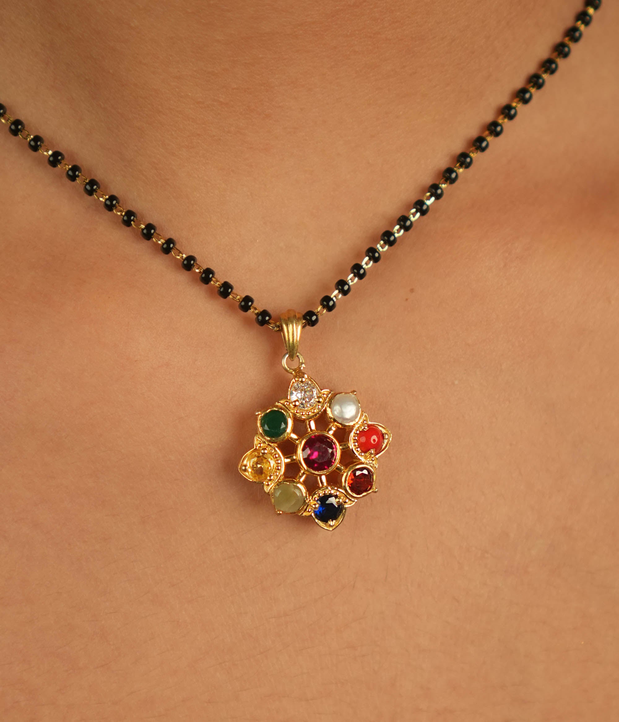 Celestial bloom reborn in a round Navratna pendant, where vibrant gems whisper ancient wisdom with modern elegance.