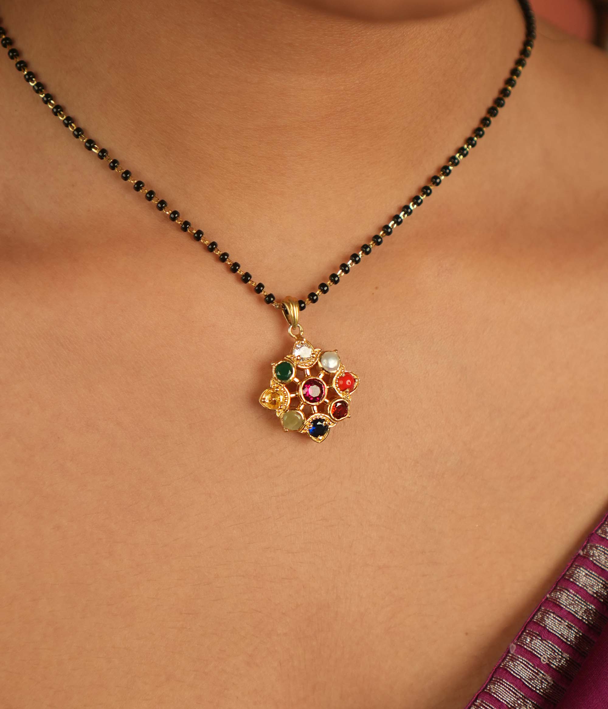 Celestial bloom reborn in a round Navratna pendant, where vibrant gems whisper ancient wisdom with modern elegance.