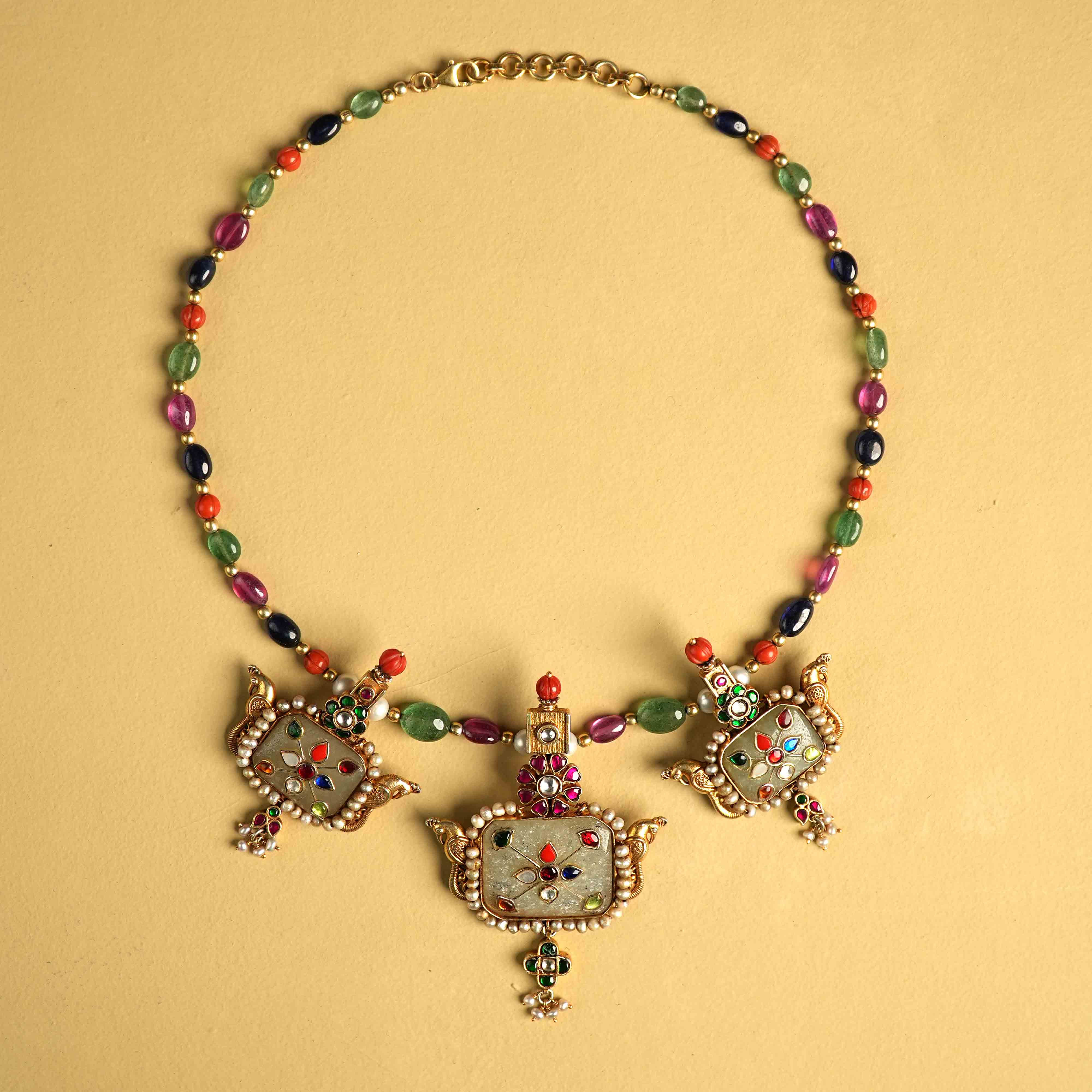 Regal 92.5 sterling silver choker featuring three bold, multi-hued natural gemstones. The stones are intricately engraved with vintage meenakari, inspired by the opulence of Rajput jewelry, exuding timeless elegance and commanding attention.