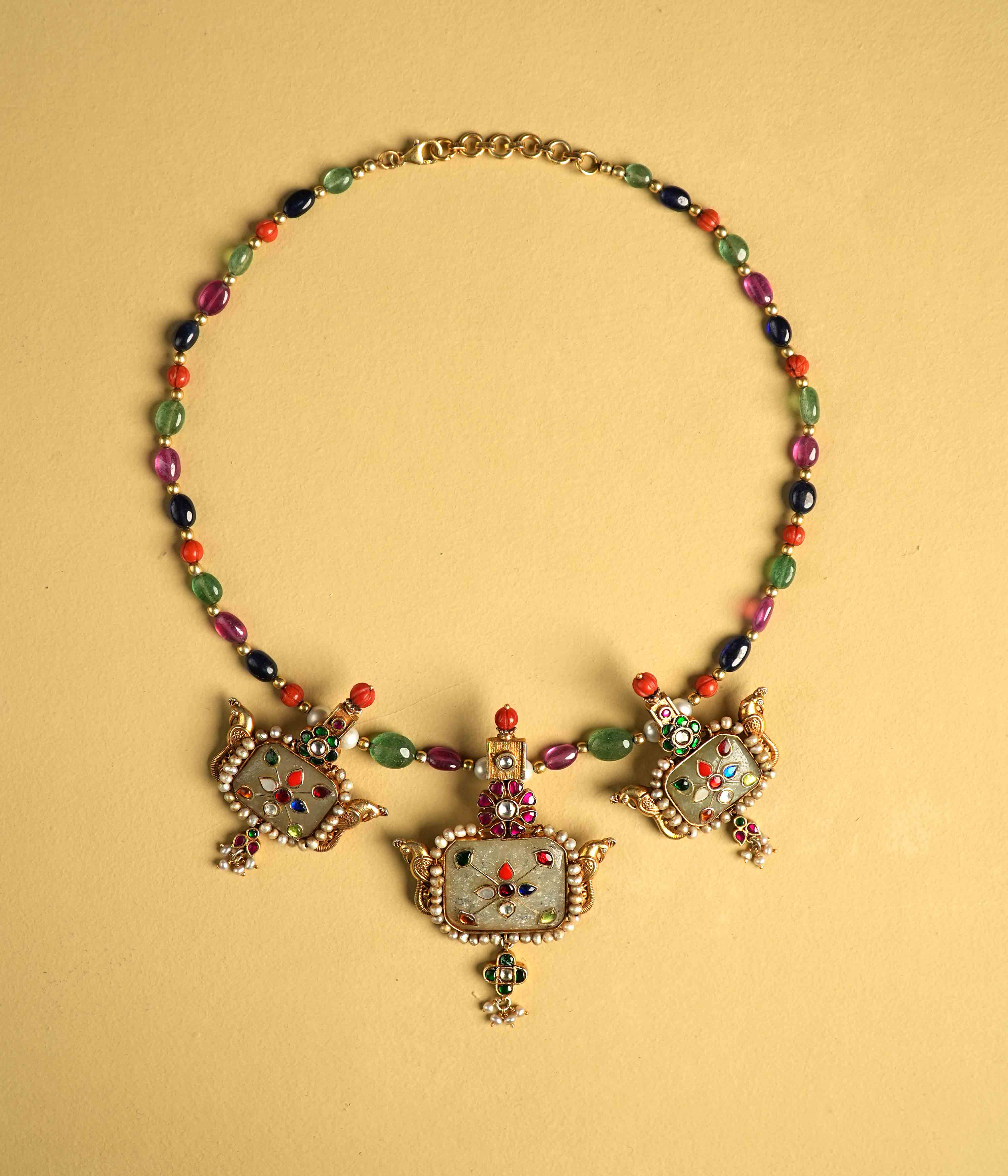 Regal 92.5 sterling silver choker featuring three bold, multi-hued natural gemstones. The stones are intricately engraved with vintage meenakari, inspired by the opulence of Rajput jewelry, exuding timeless elegance and commanding attention.