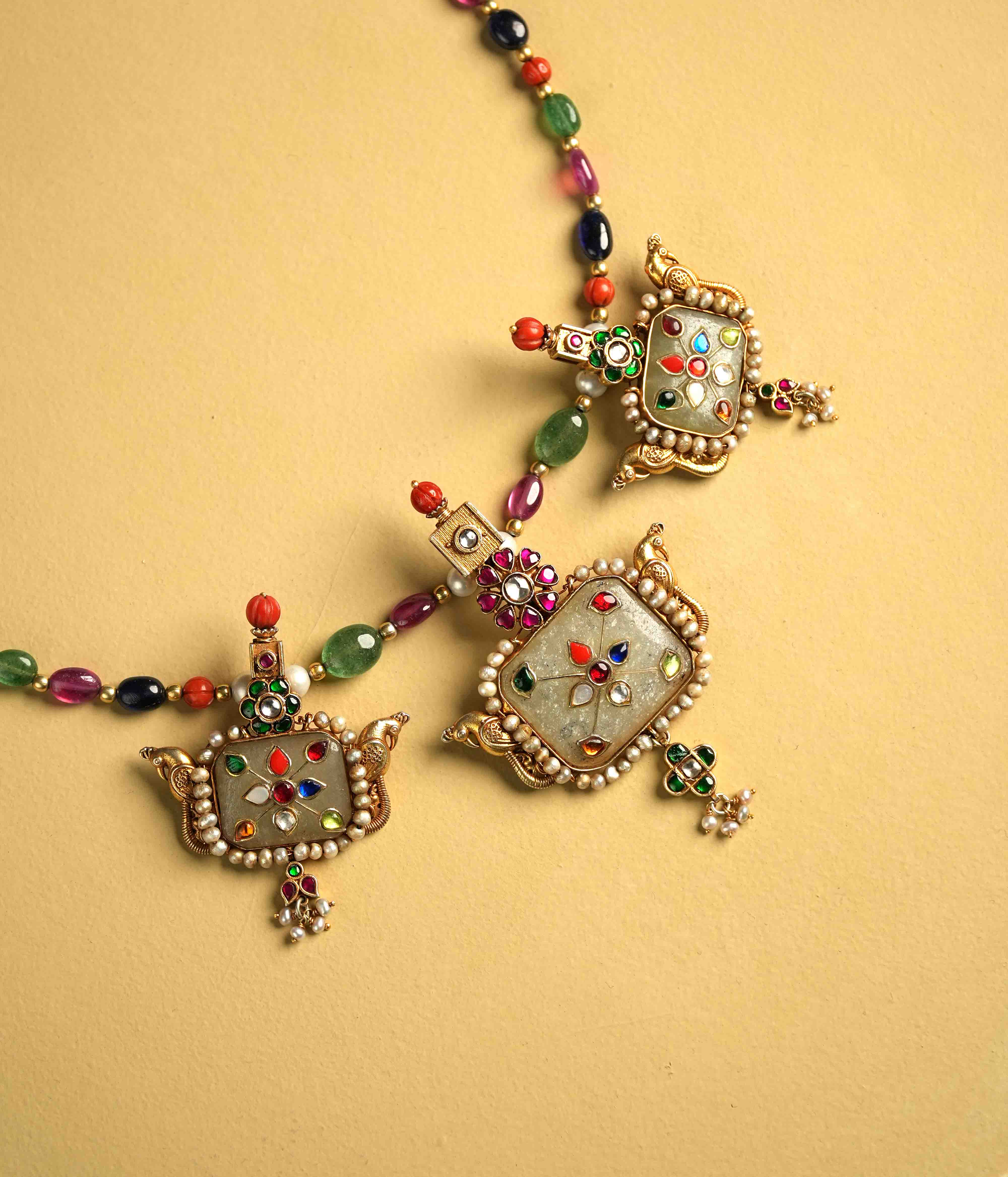 Regal 92.5 sterling silver choker featuring three bold, multi-hued natural gemstones. The stones are intricately engraved with vintage meenakari, inspired by the opulence of Rajput jewelry, exuding timeless elegance and commanding attention.