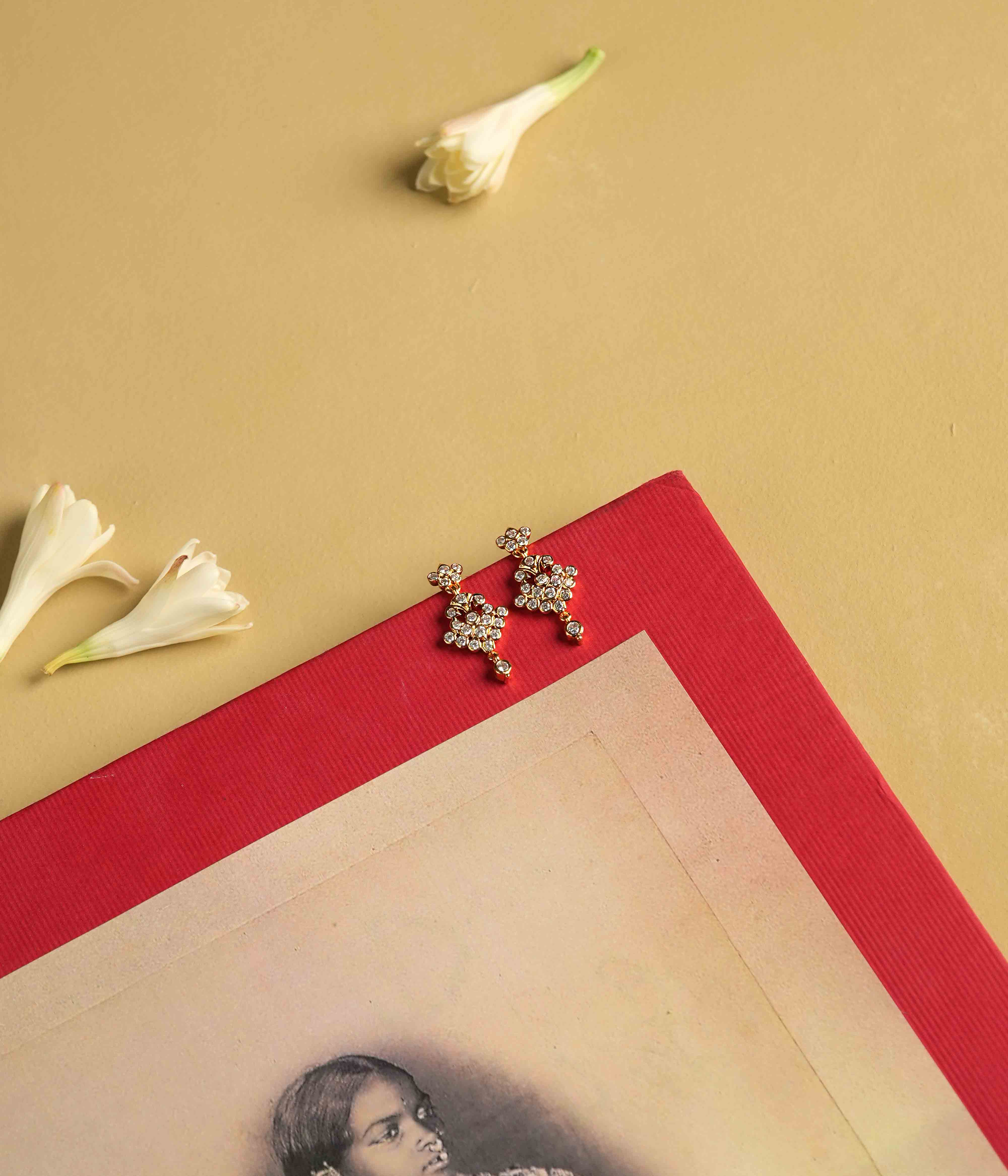 These moissanite earrings, crafted from 92.5 sterling silver with a South screw fastening, sparkle with vintage charm, embodying a timeless brilliance inspired by the revered stone settings of Chettinad and featuring Swarovski stones.