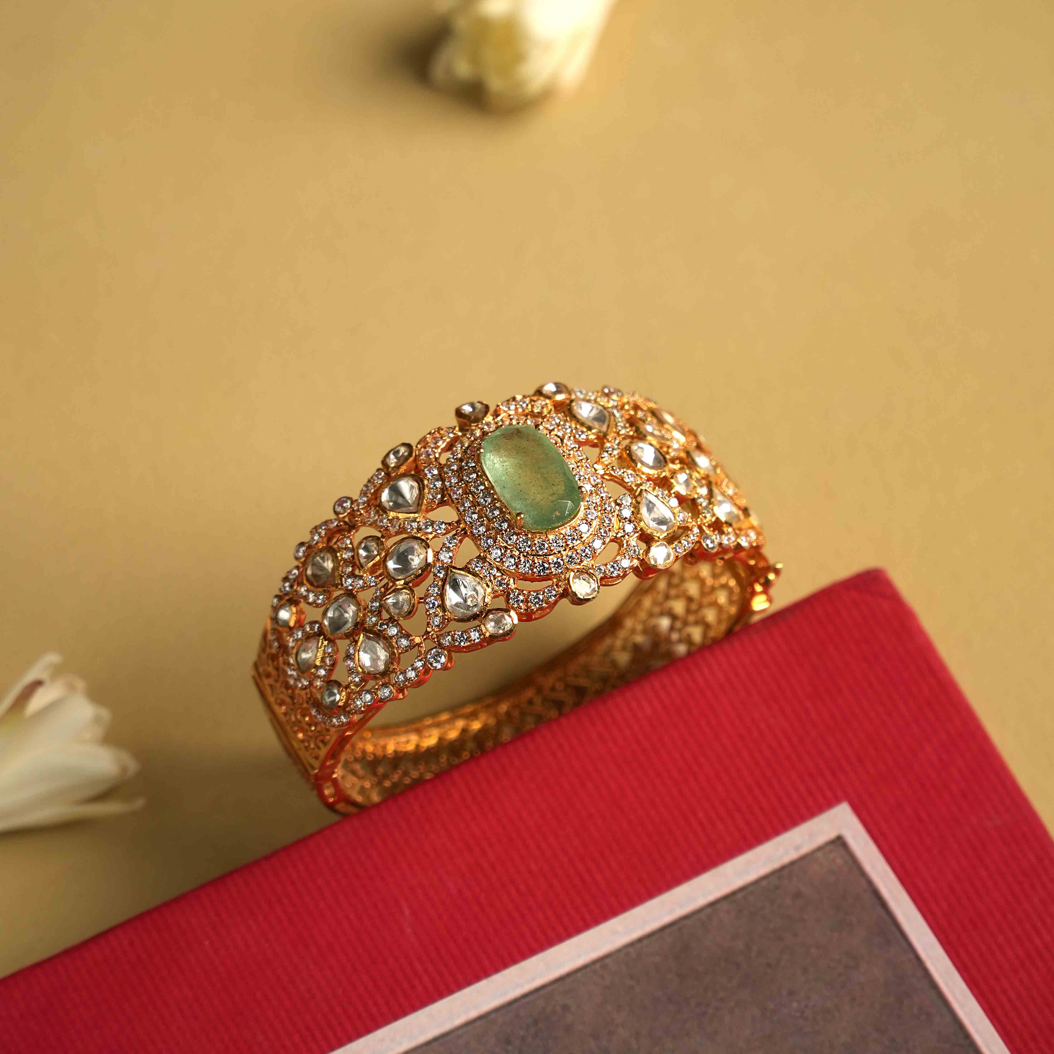 Elegant 92.5 sterling silver bracelet featuring a bold green Mossonite Polki stone at its center. The intricate craftsmanship showcases the brilliant sparkle of moissanite and polki stones, creating a luxurious and sophisticated design. A true statement piece, exuding regal splendor and timeless elegance