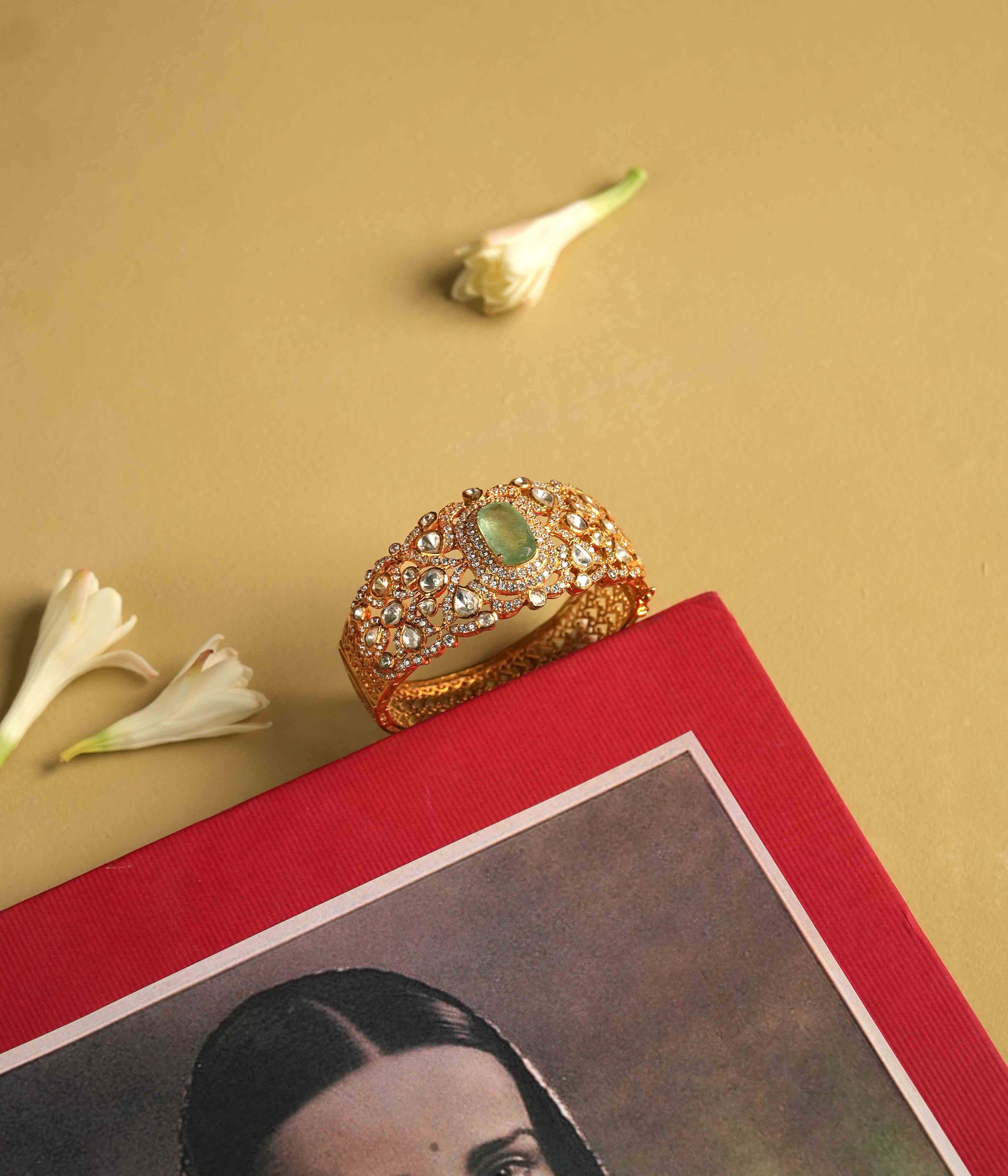 Elegant 92.5 sterling silver bracelet featuring a bold green Mossonite Polki stone at its center. The intricate craftsmanship showcases the brilliant sparkle of moissanite and polki stones, creating a luxurious and sophisticated design. A true statement piece, exuding regal splendor and timeless elegance