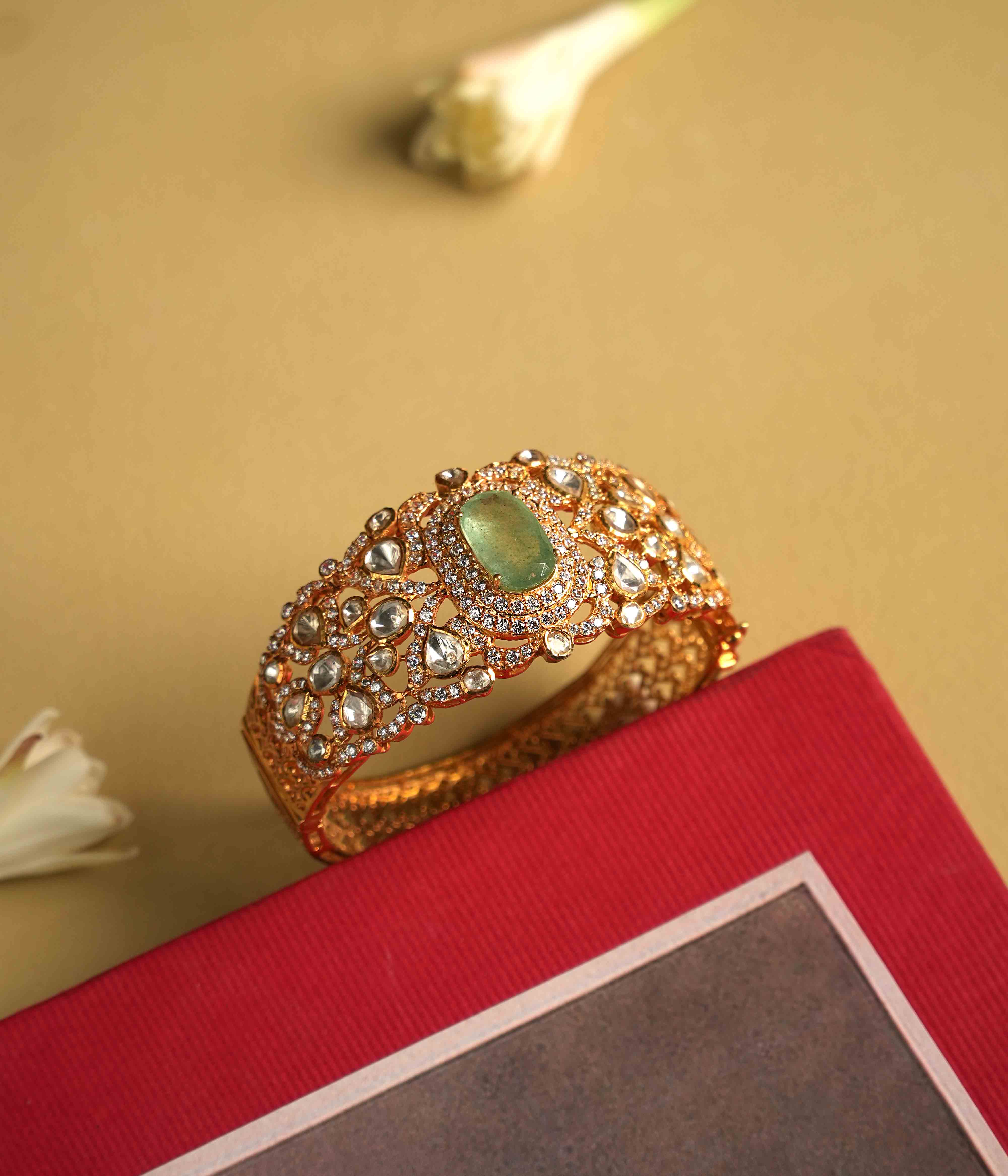 Elegant 92.5 sterling silver bracelet featuring a bold green Mossonite Polki stone at its center. The intricate craftsmanship showcases the brilliant sparkle of moissanite and polki stones, creating a luxurious and sophisticated design. A true statement piece, exuding regal splendor and timeless elegance