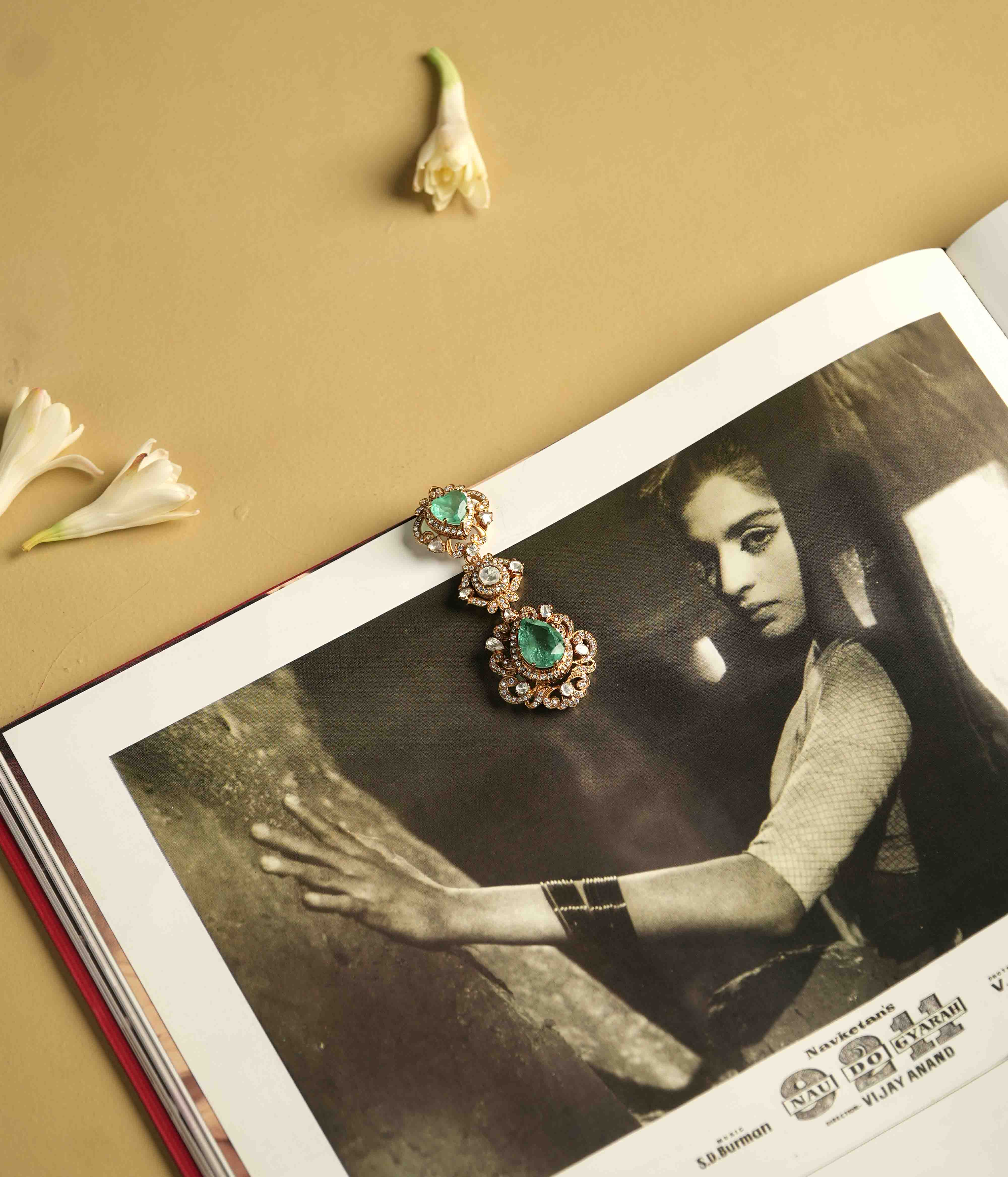 A statement pendant crafted from handmade 92.5 sterling silver with 14ct dark antique gold plating, featuring moissanite polki stones, a green gemstone, and CZ stones, showcasing a bold, cultured emerald teardrop center and a Victorian finish.