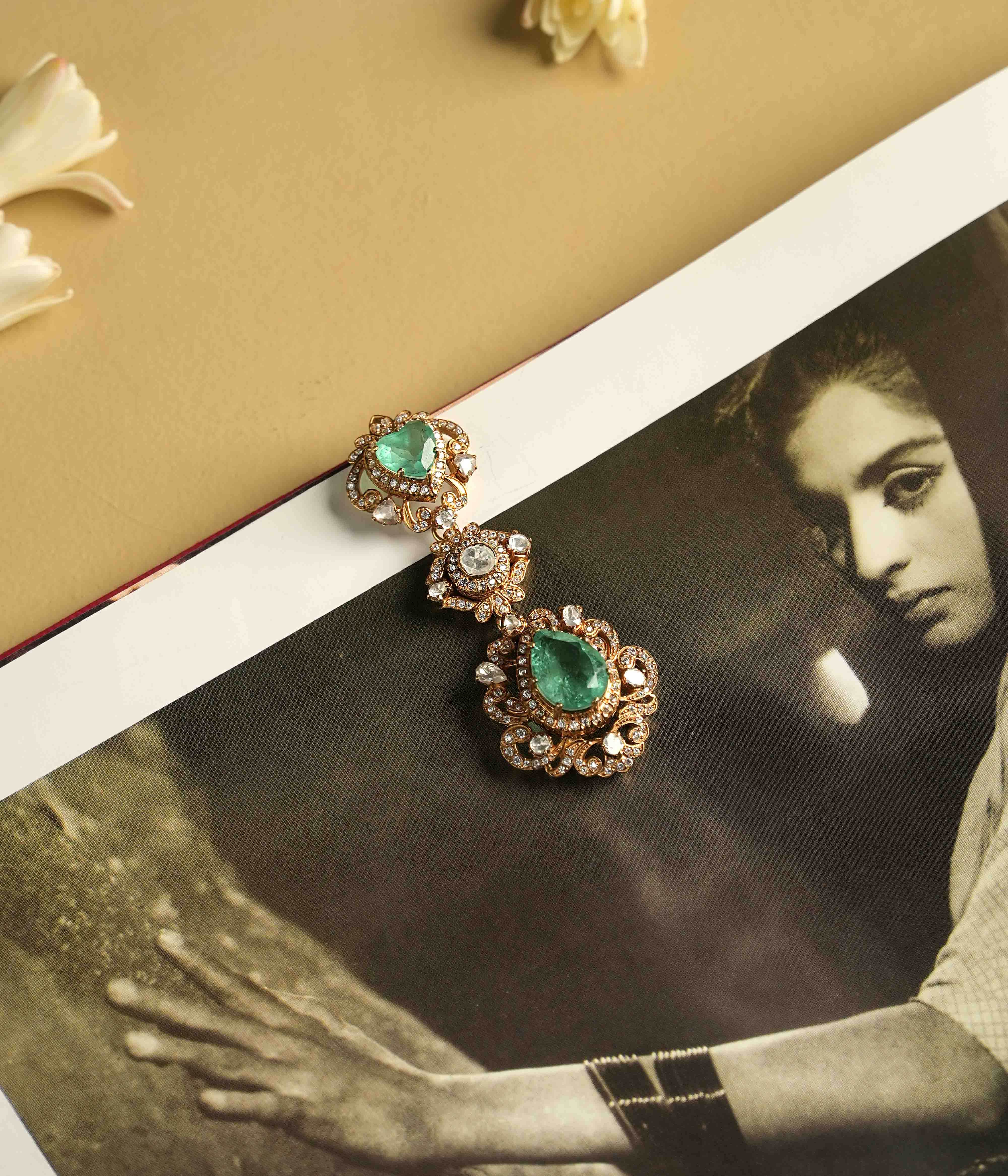A statement pendant crafted from handmade 92.5 sterling silver with 14ct dark antique gold plating, featuring moissanite polki stones, a green gemstone, and CZ stones, showcasing a bold, cultured emerald teardrop center and a Victorian finish.