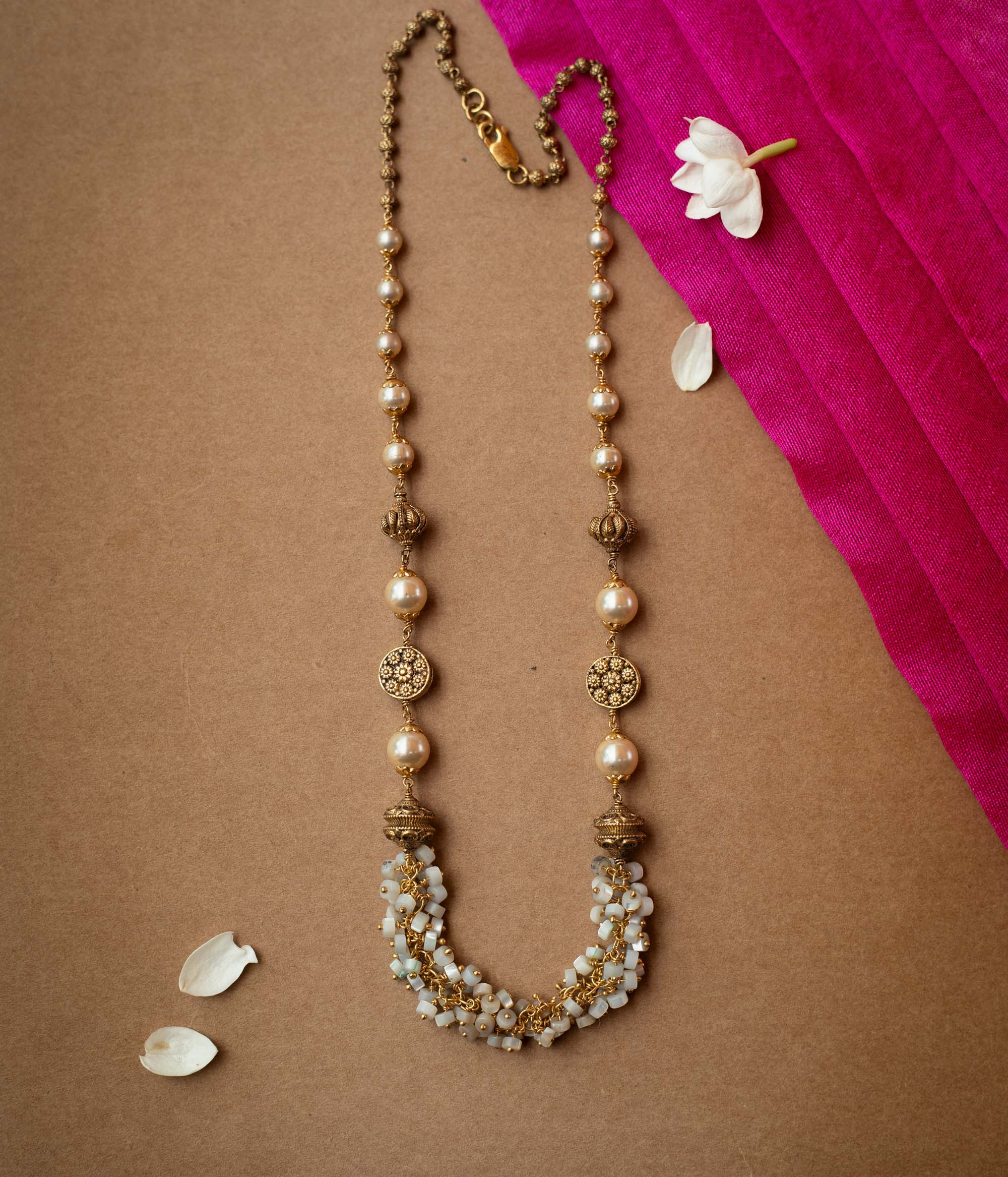 A multi-strand chain necklace made entirely of white pearls.