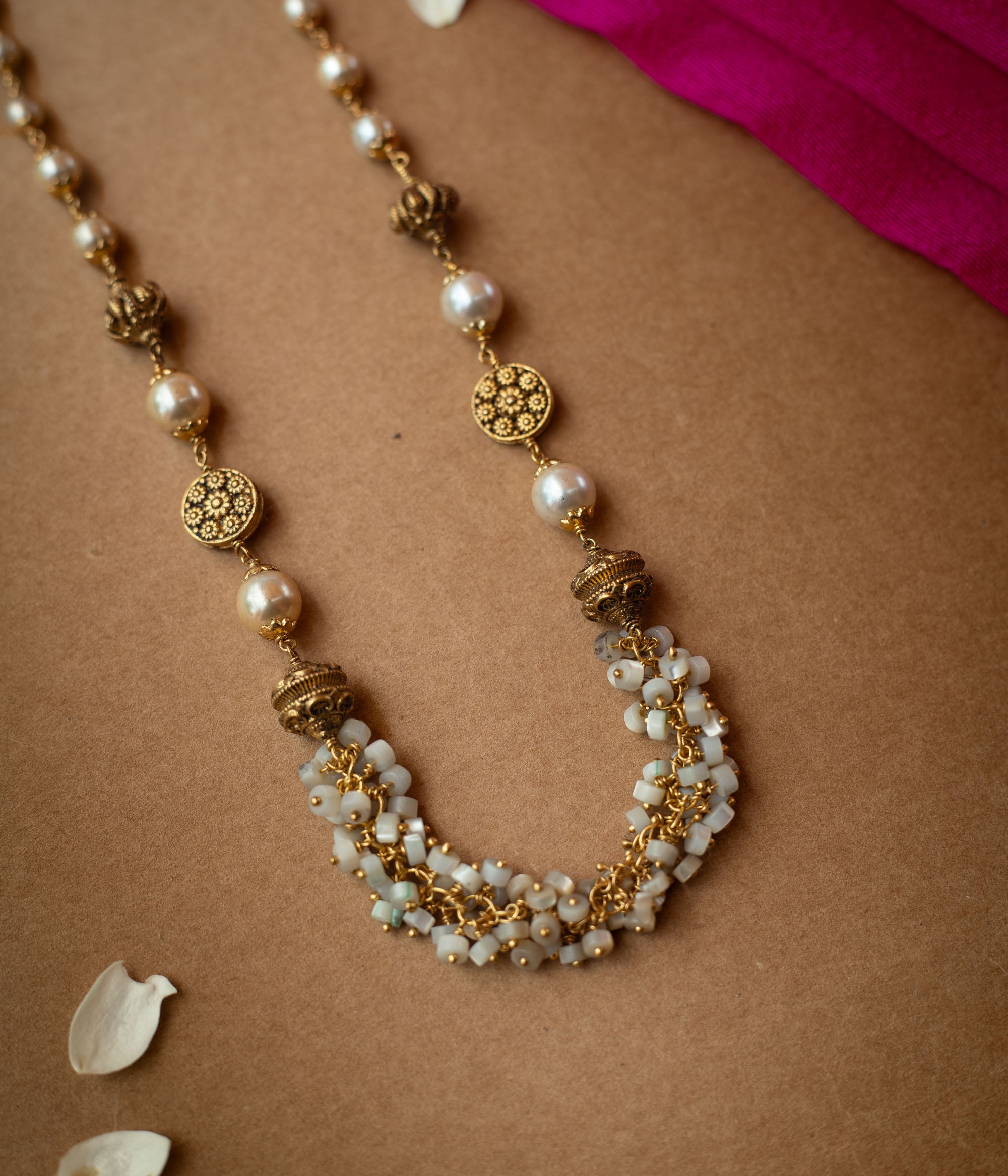 A multi-strand chain necklace made entirely of white pearls.