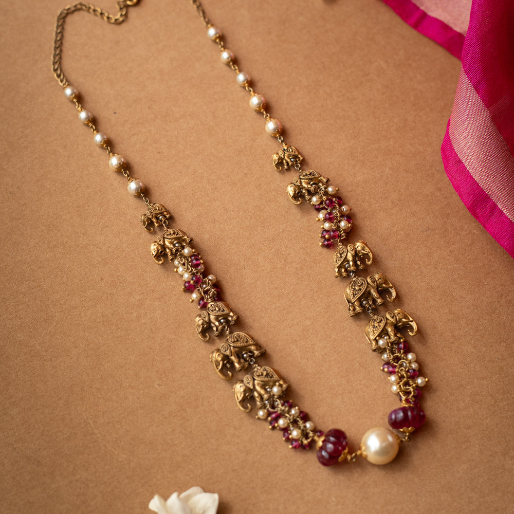 A two-strand chain with a strand of red beads and a strand of pearls.