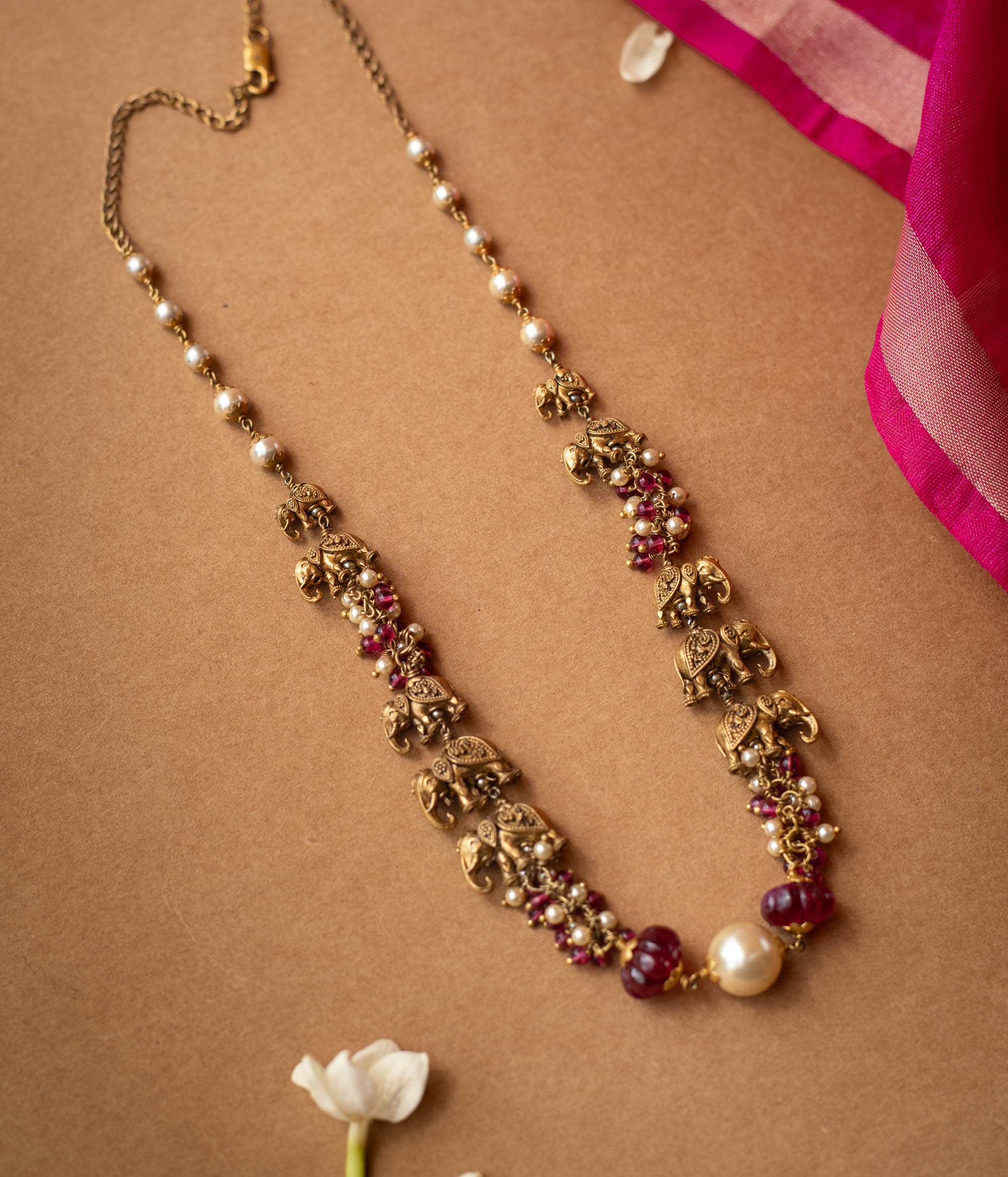 A two-strand chain with a strand of red beads and a strand of pearls.