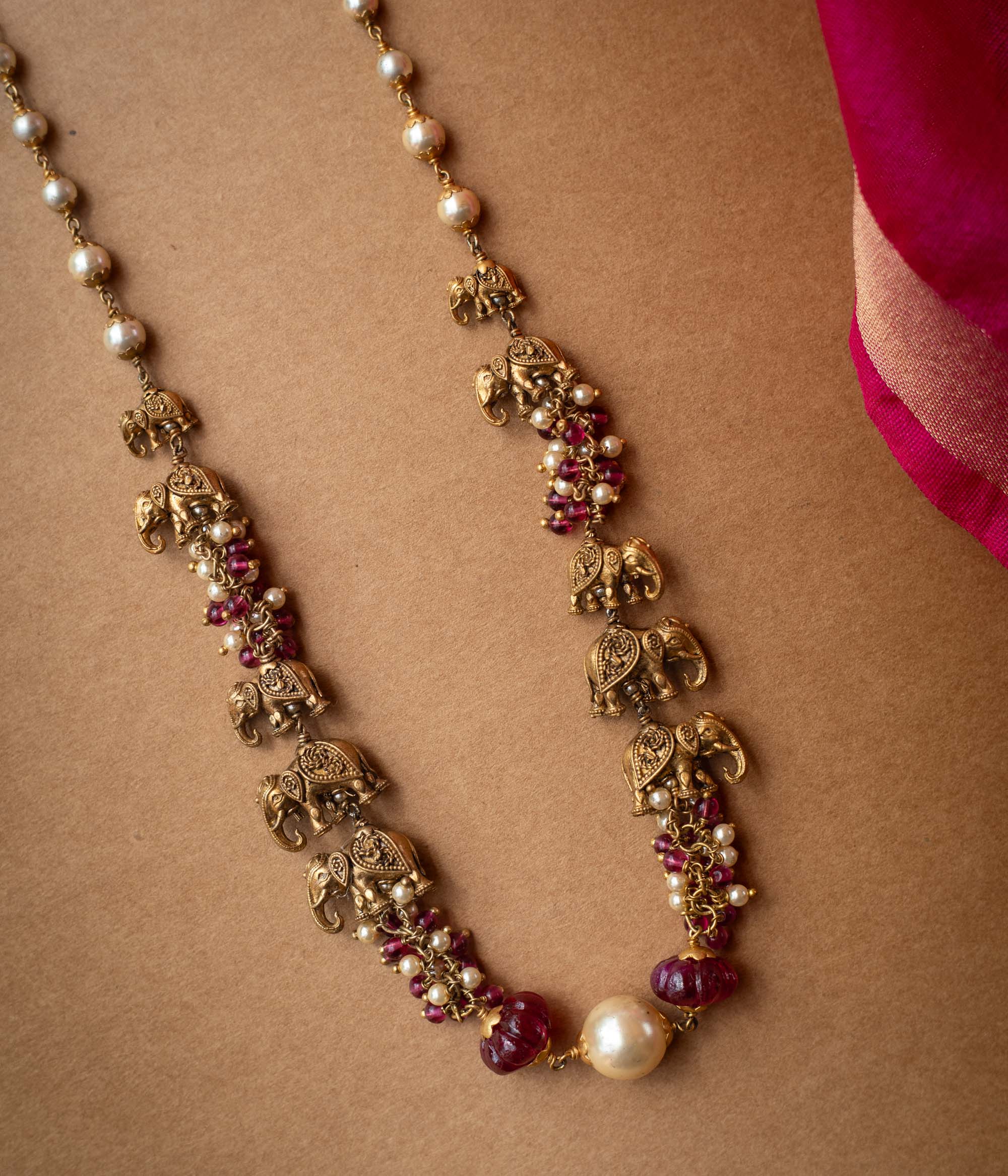 A two-strand chain with a strand of red beads and a strand of pearls.
