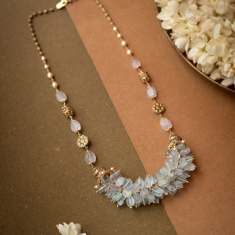A thick, braided multi-strand chain necklace made entirely of white pearls.