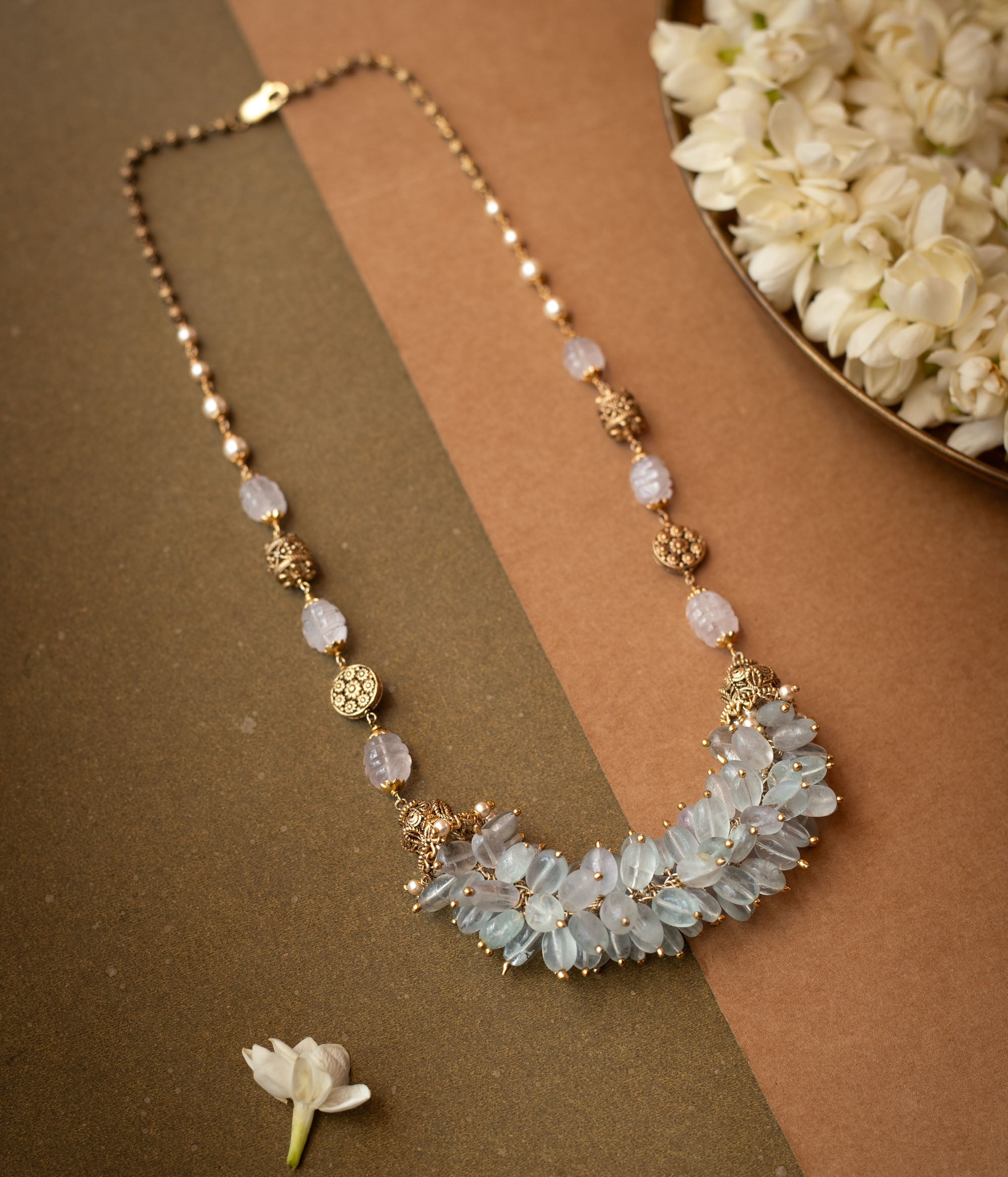 A thick, braided multi-strand chain necklace made entirely of white pearls.