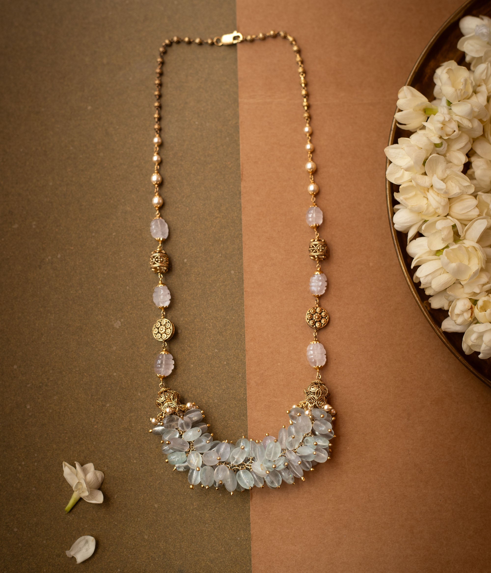 A thick, braided multi-strand chain necklace made entirely of white pearls.