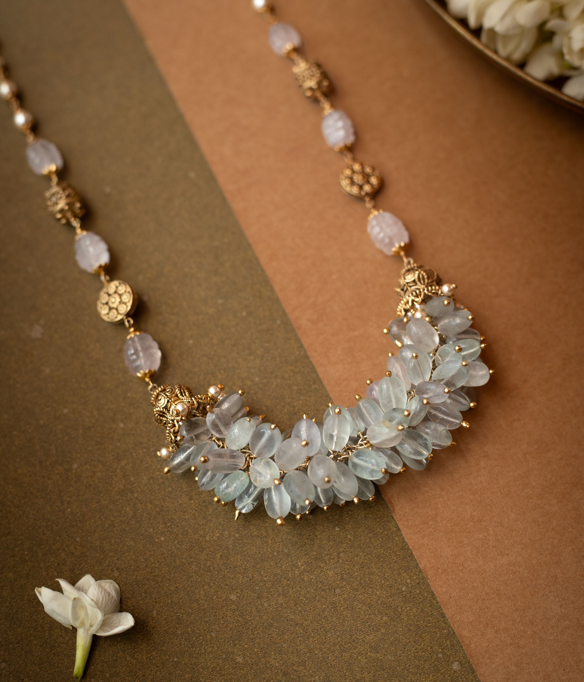 A thick, braided multi-strand chain necklace made entirely of white pearls.