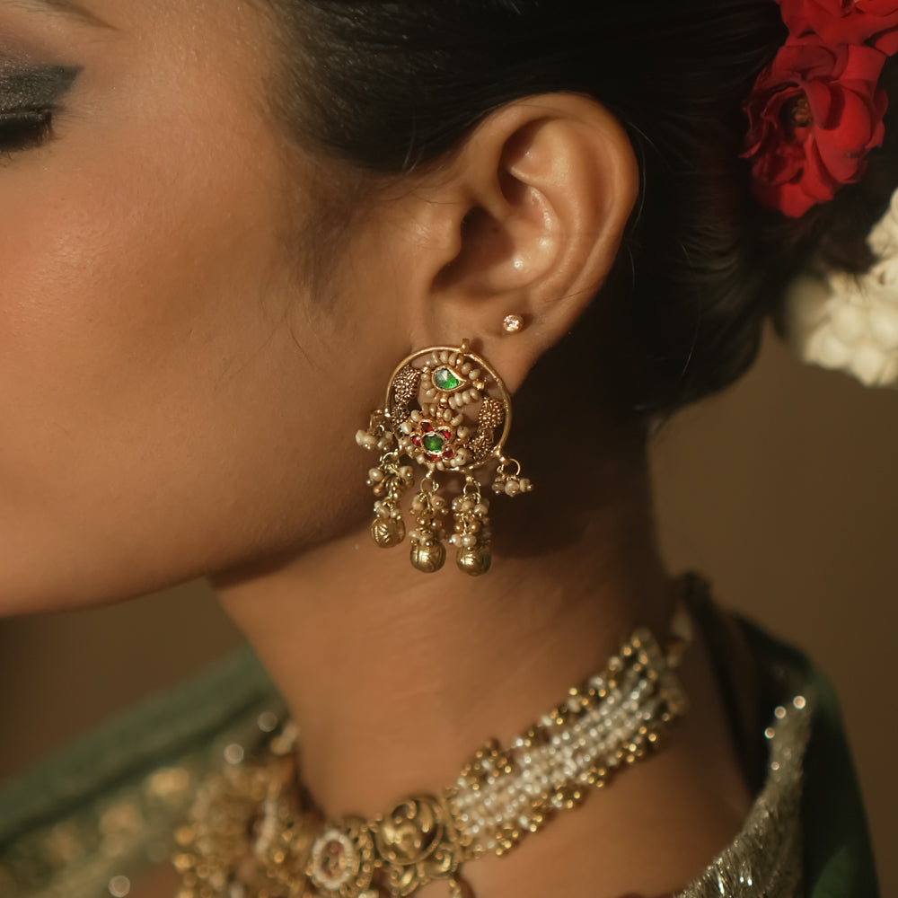 Gold Baali earrings with green and red Kundan gems and tiny bells.
