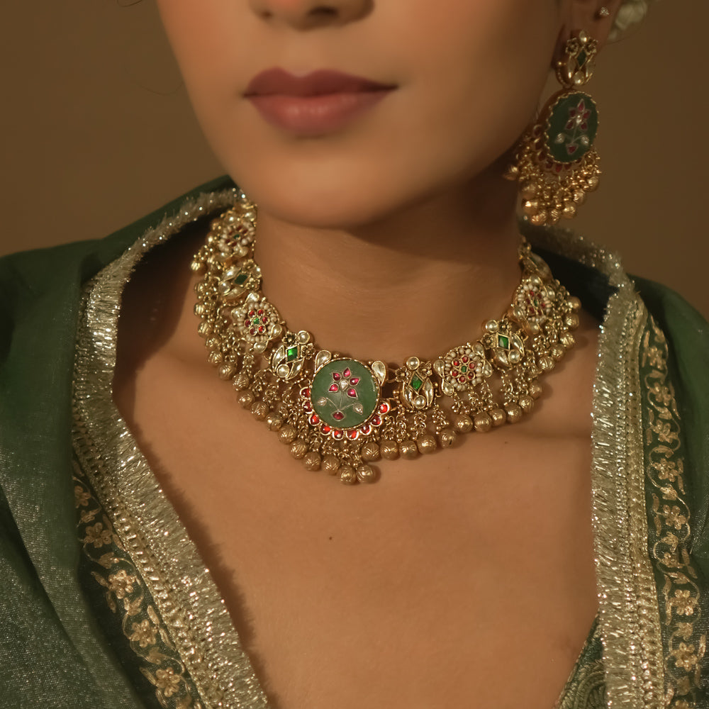 Gold-plated necklace with green enamel medallions, crimson jewels, and pearls.