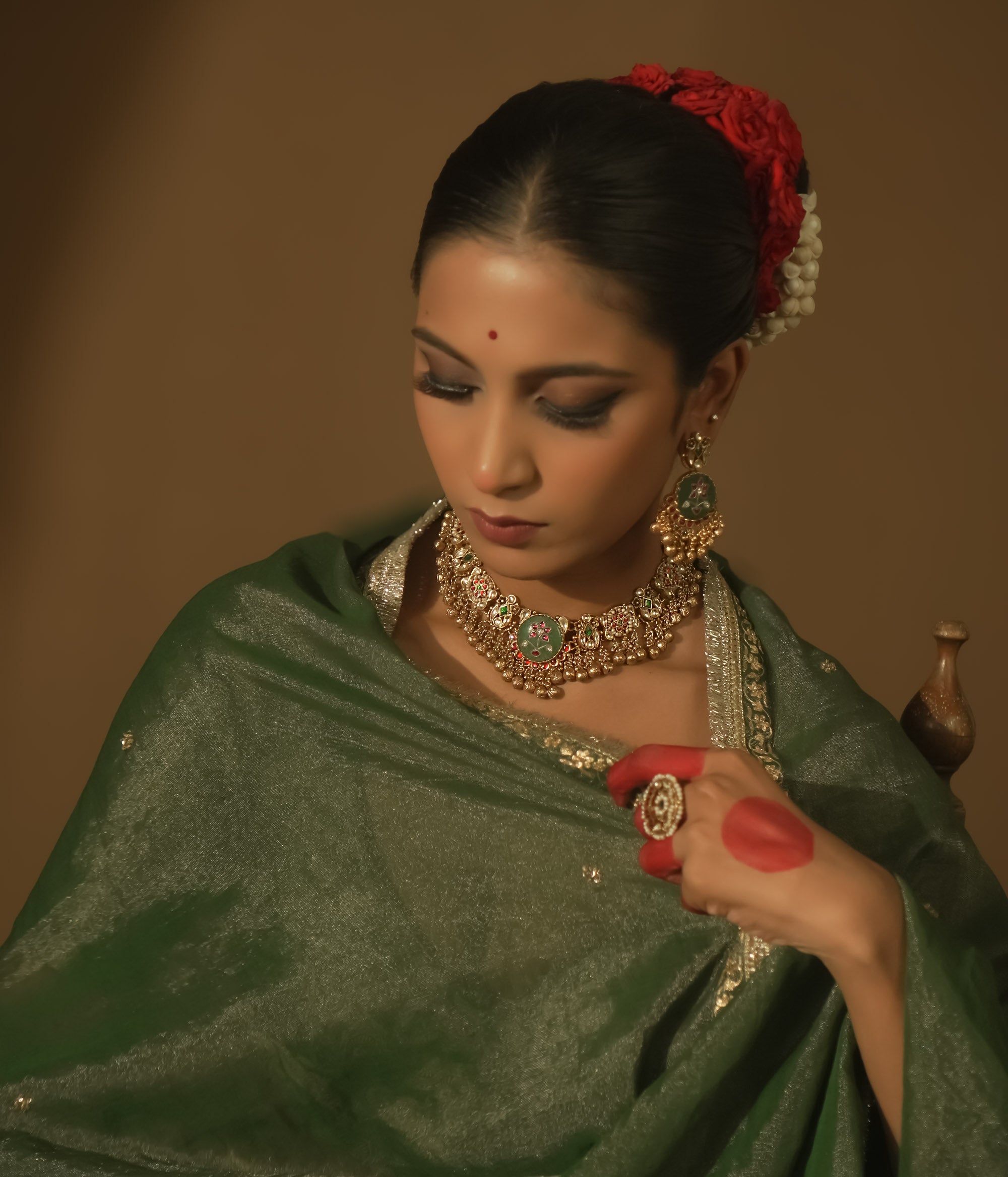 Gold-plated necklace with green enamel medallions, crimson jewels, and pearls.