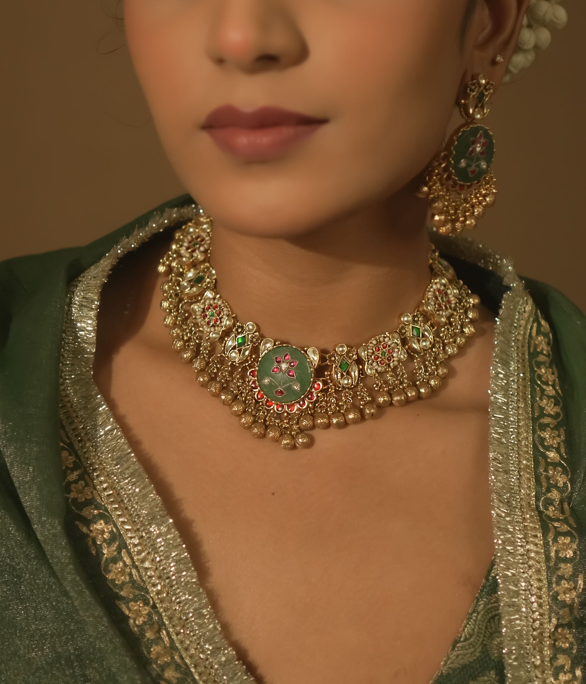 Gold-plated necklace with green enamel medallions, crimson jewels, and pearls.