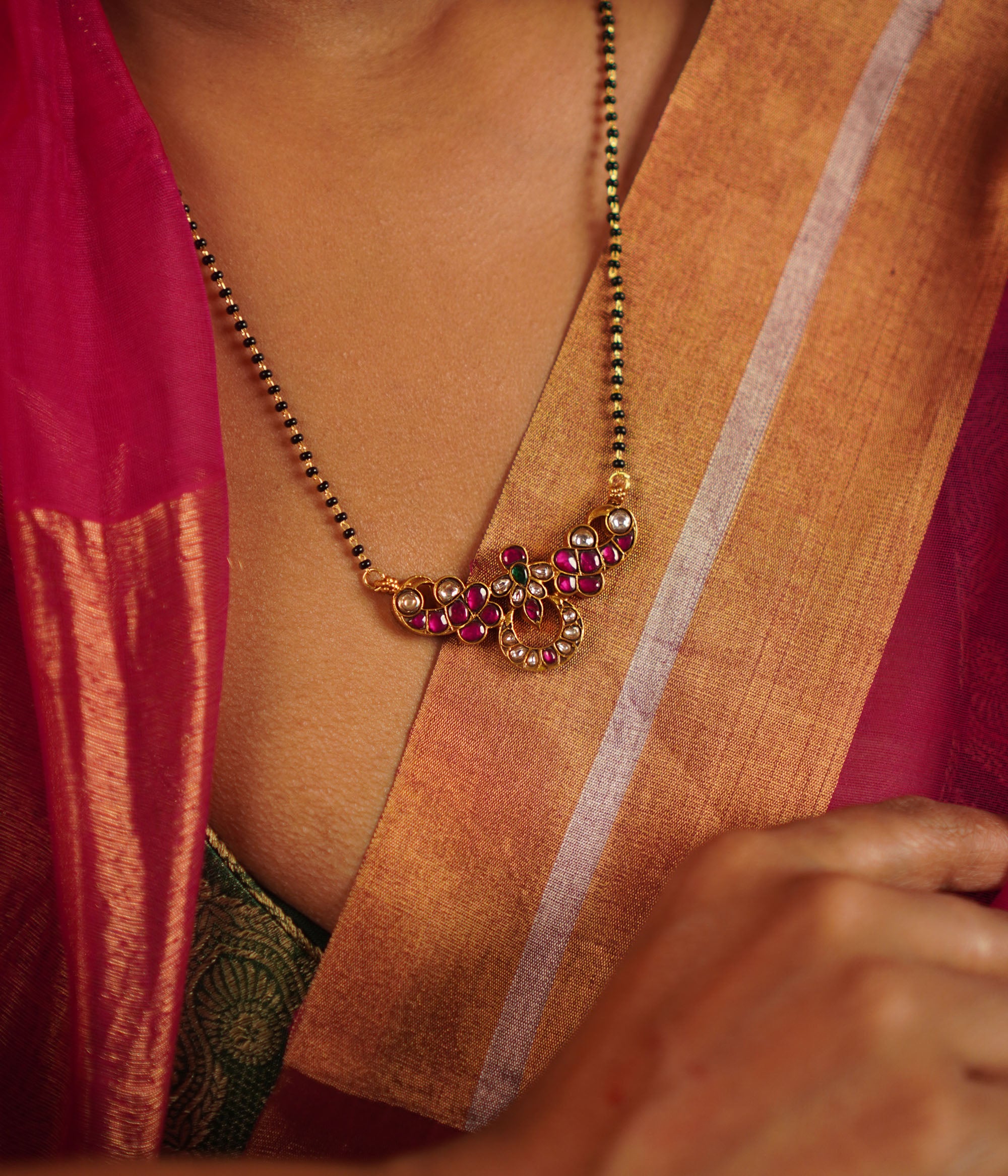 The Jaba Mangalsutra, handcrafted in gold-plated silver, showcases vibrant kundan stones paired with traditional black beads. A timeless design with a modern twist, it beautifully blends heritage craftsmanship with contemporary elegance.
