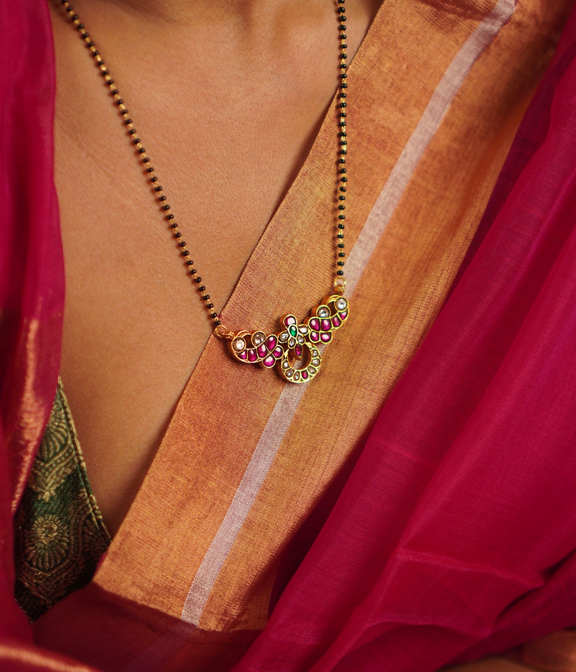 The Jaba Mangalsutra, handcrafted in gold-plated silver, showcases vibrant kundan stones paired with traditional black beads. A timeless design with a modern twist, it beautifully blends heritage craftsmanship with contemporary elegance.