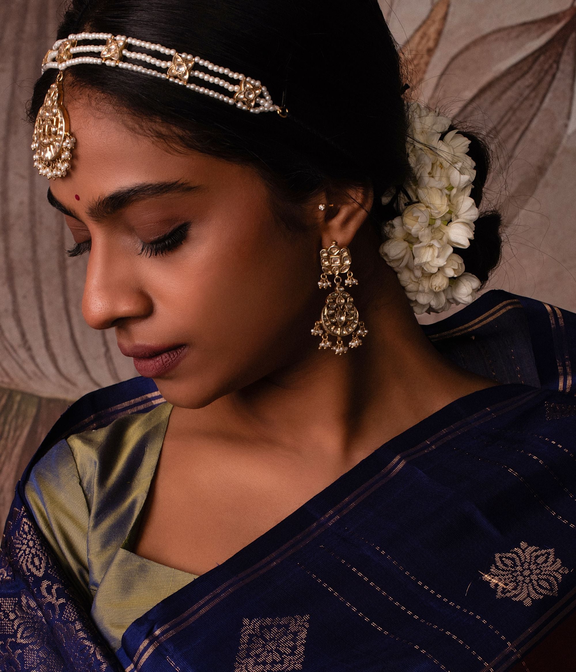 Gold-plated silver tikka featuring a delicate moon-shaped pendant, adorned with shimmering white sapphires and elegant pearls, exuding a timeless and graceful traditional charm.