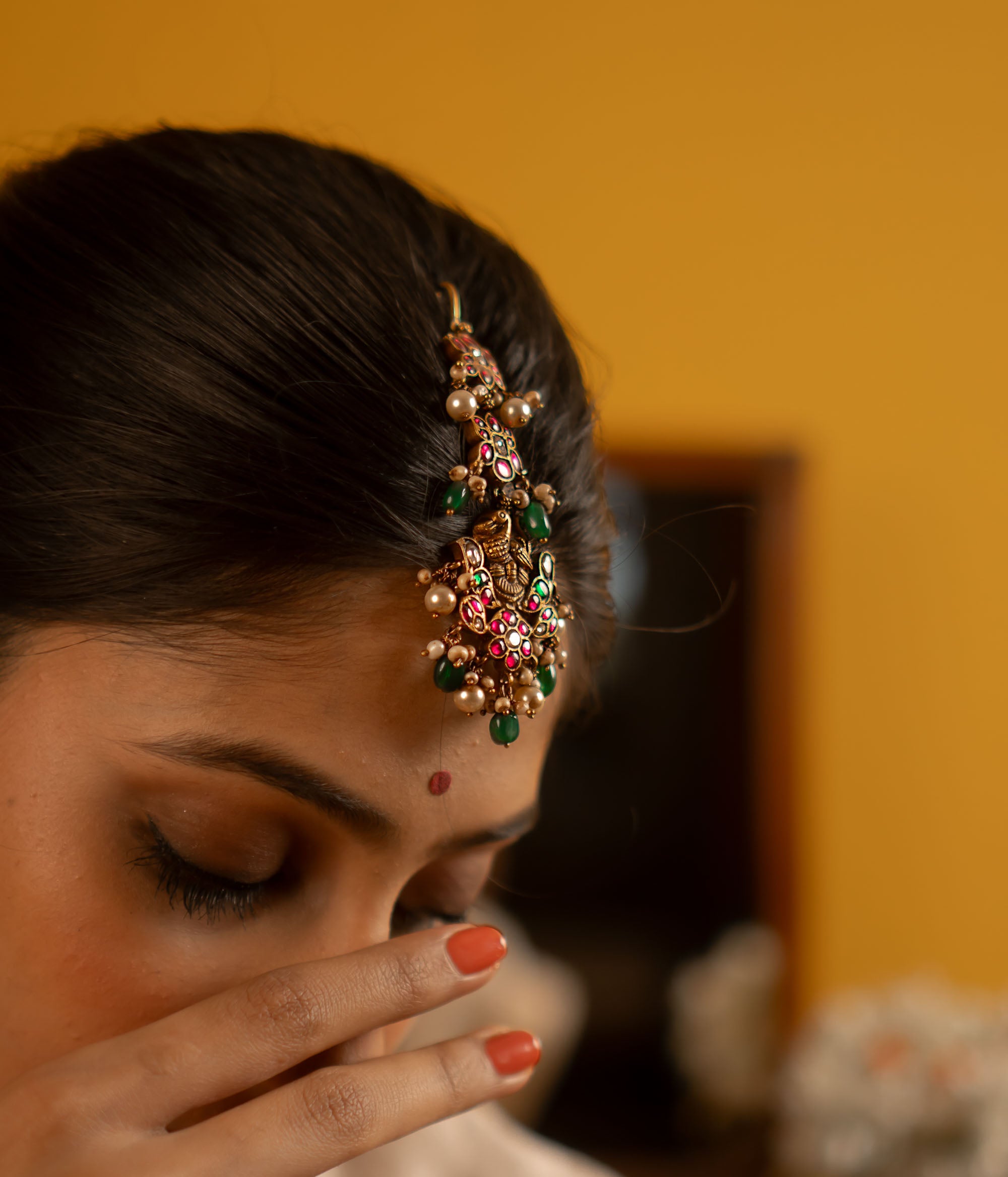 Traditional Indian maangtika with kundan stones and pearls