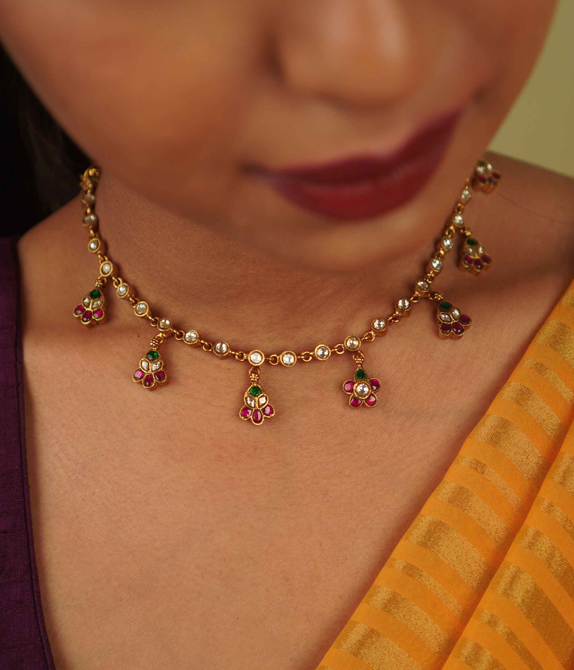 Jasmira Necklace: Graceful floral droplets adorned with red, white, and green kundans, set in gold-plated silver—timeless elegance redefined.