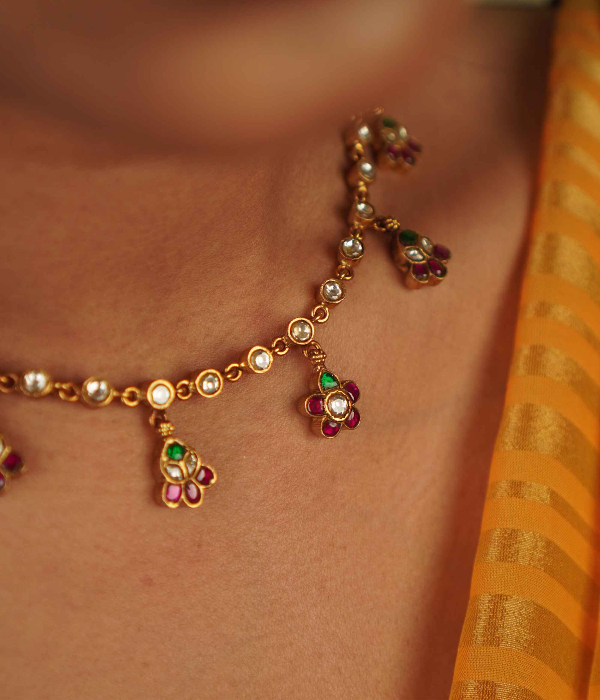 Jasmira Necklace: Graceful floral droplets adorned with red, white, and green kundans, set in gold-plated silver—timeless elegance redefined.