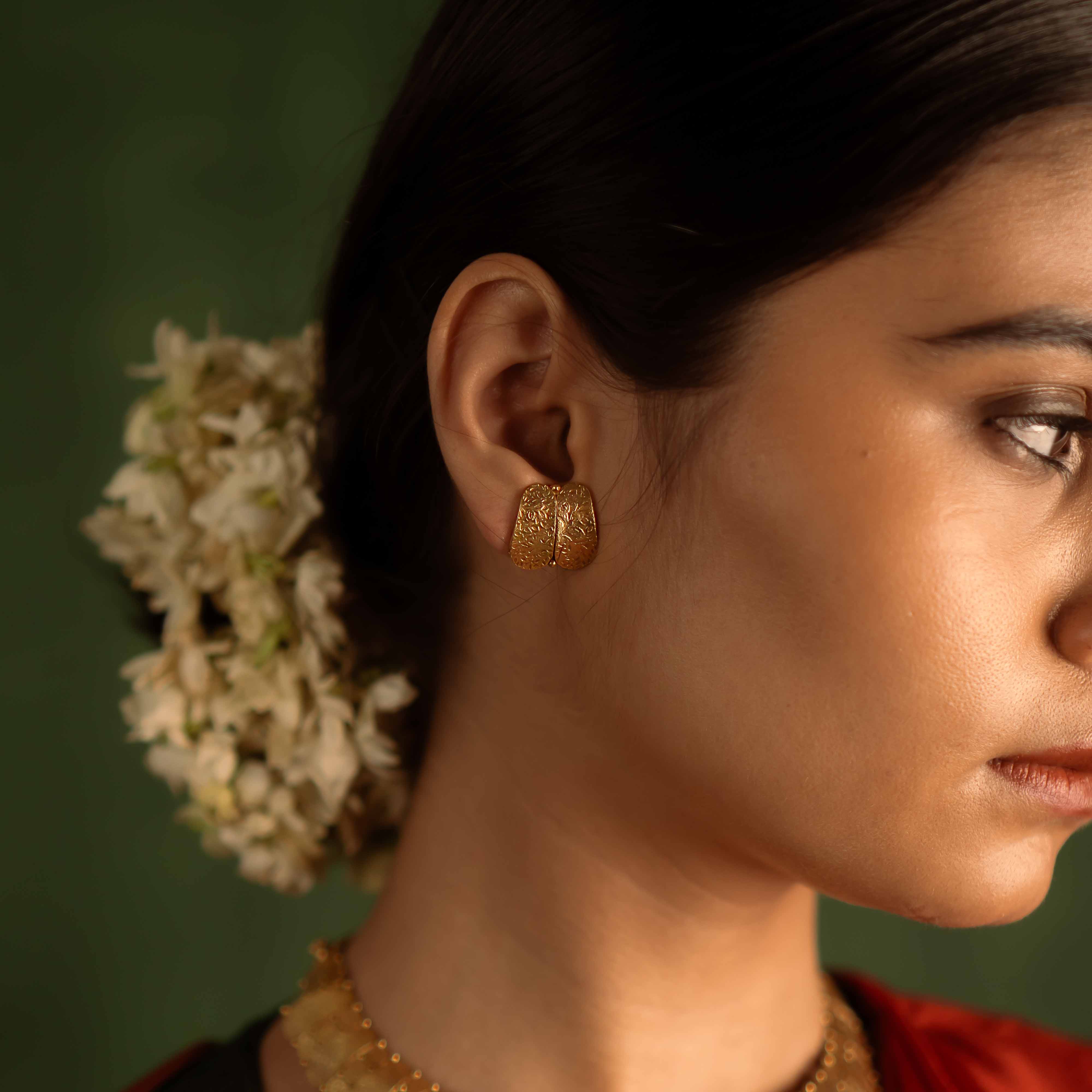 Timeless tradition reimagined. Jaswand stud earrings: Gold-plated silver with intricate craftsmanship, honoring heritage and adding elegance to the modern woman.