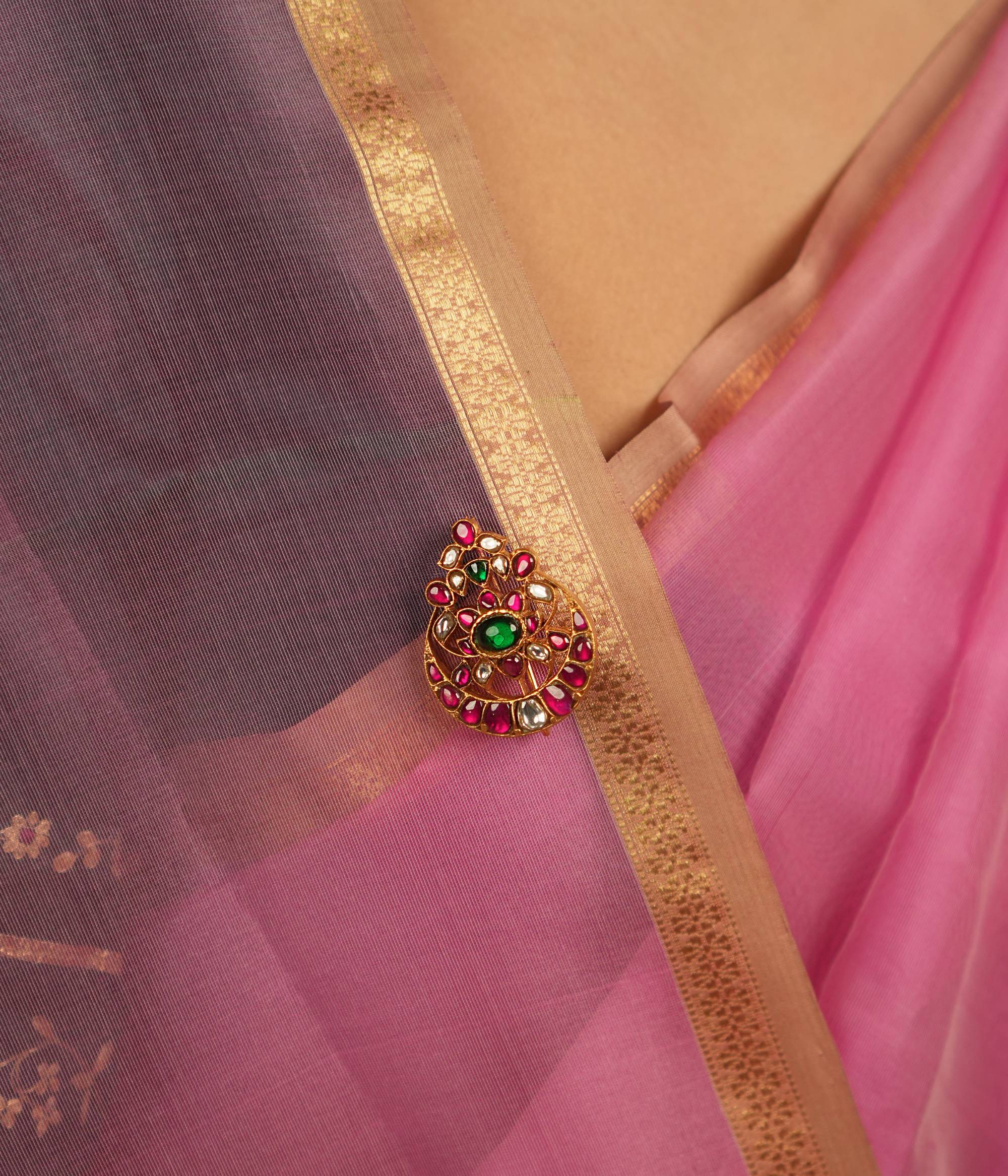 This brooch embodies elegance and heritage, adorned with green, red, and white Kundan stones, exuding timeless allure.